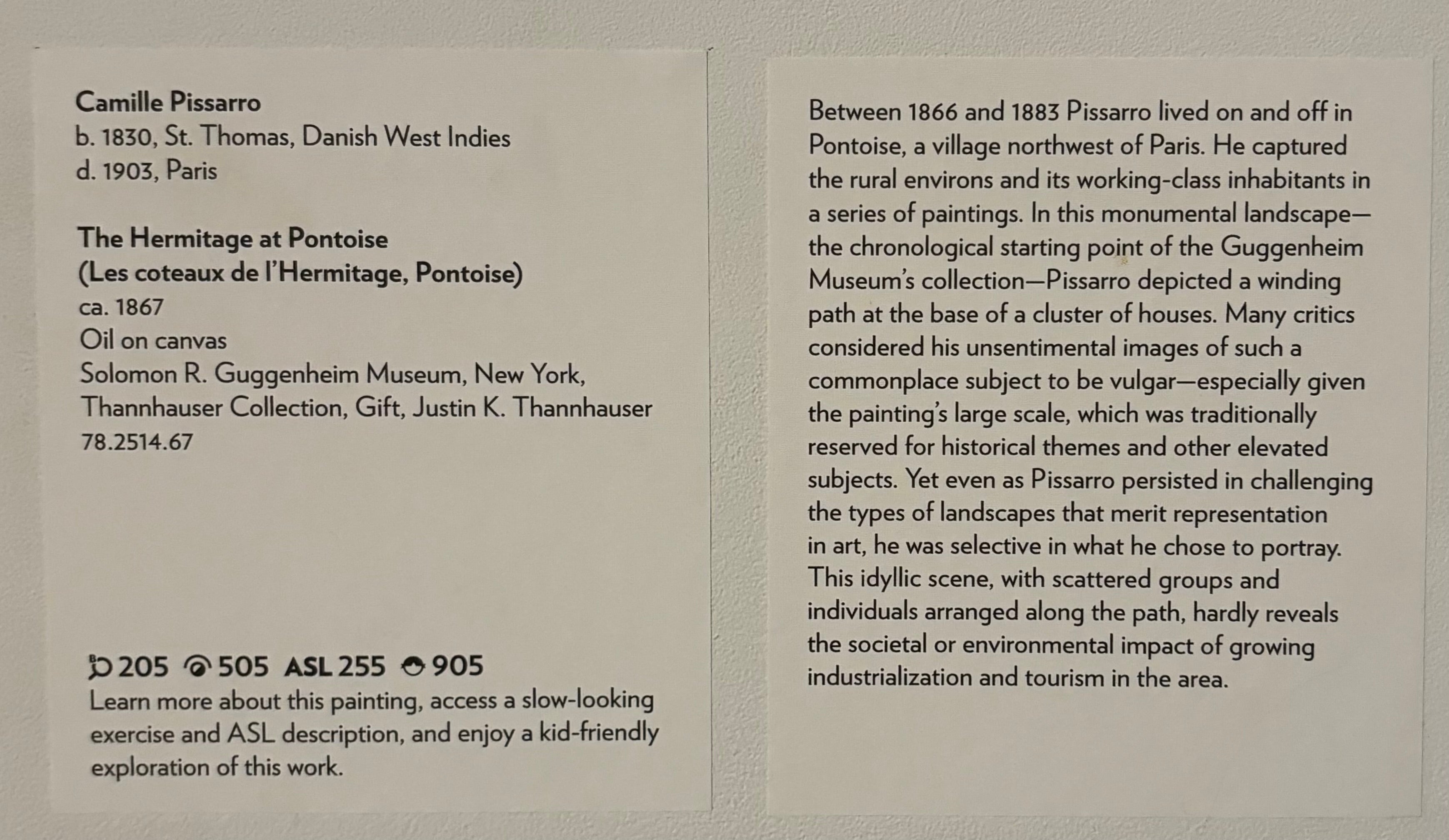 Two rectangular labels affixed to a white wall. The left label lists the artist's name, biographical information, collection details about the painting, and technology tags. The right label shares a brief interpretive description of Pissarro's art practice and approach to landscape painting. 