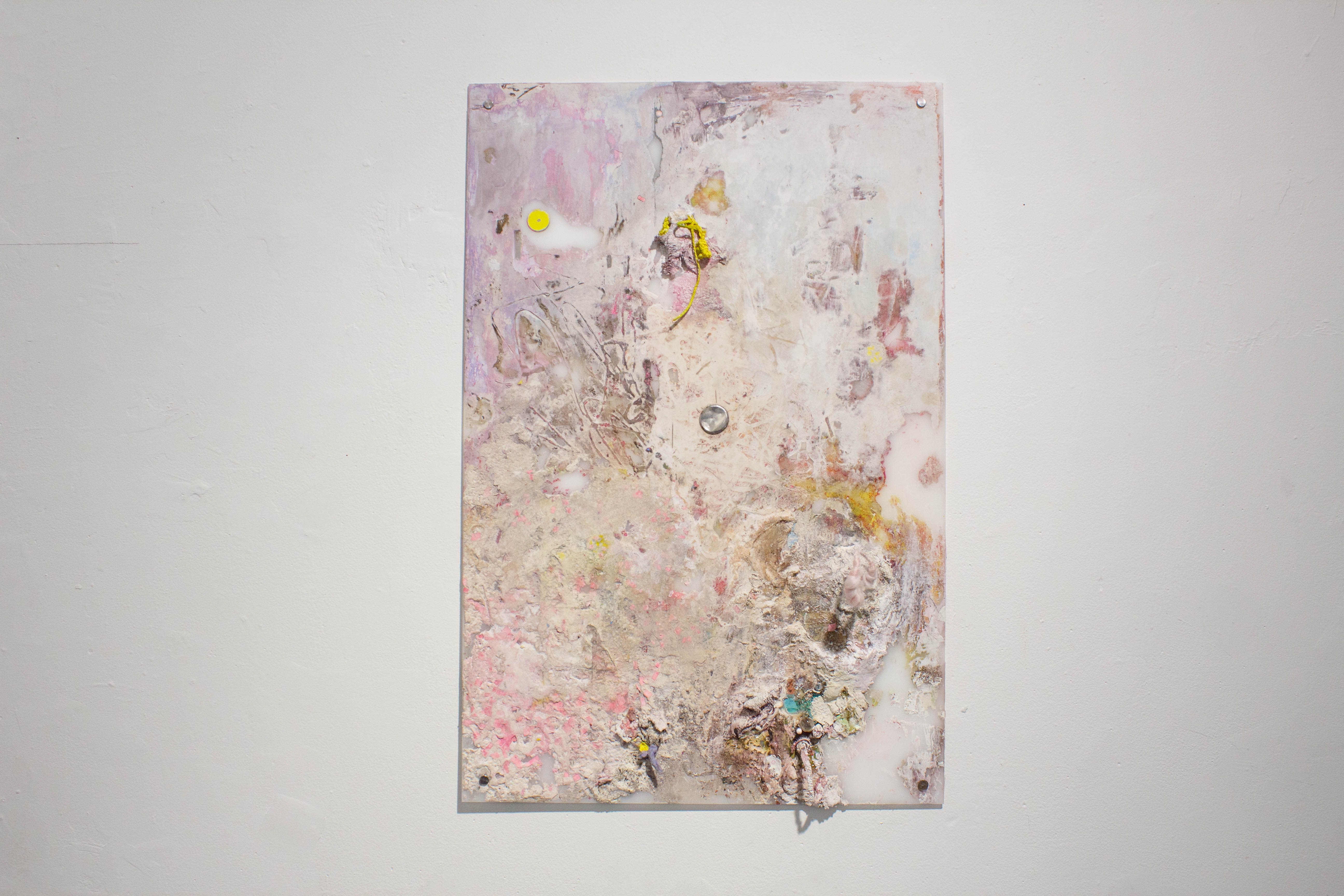 a pink mixed media painting with a metal circle in its center. 