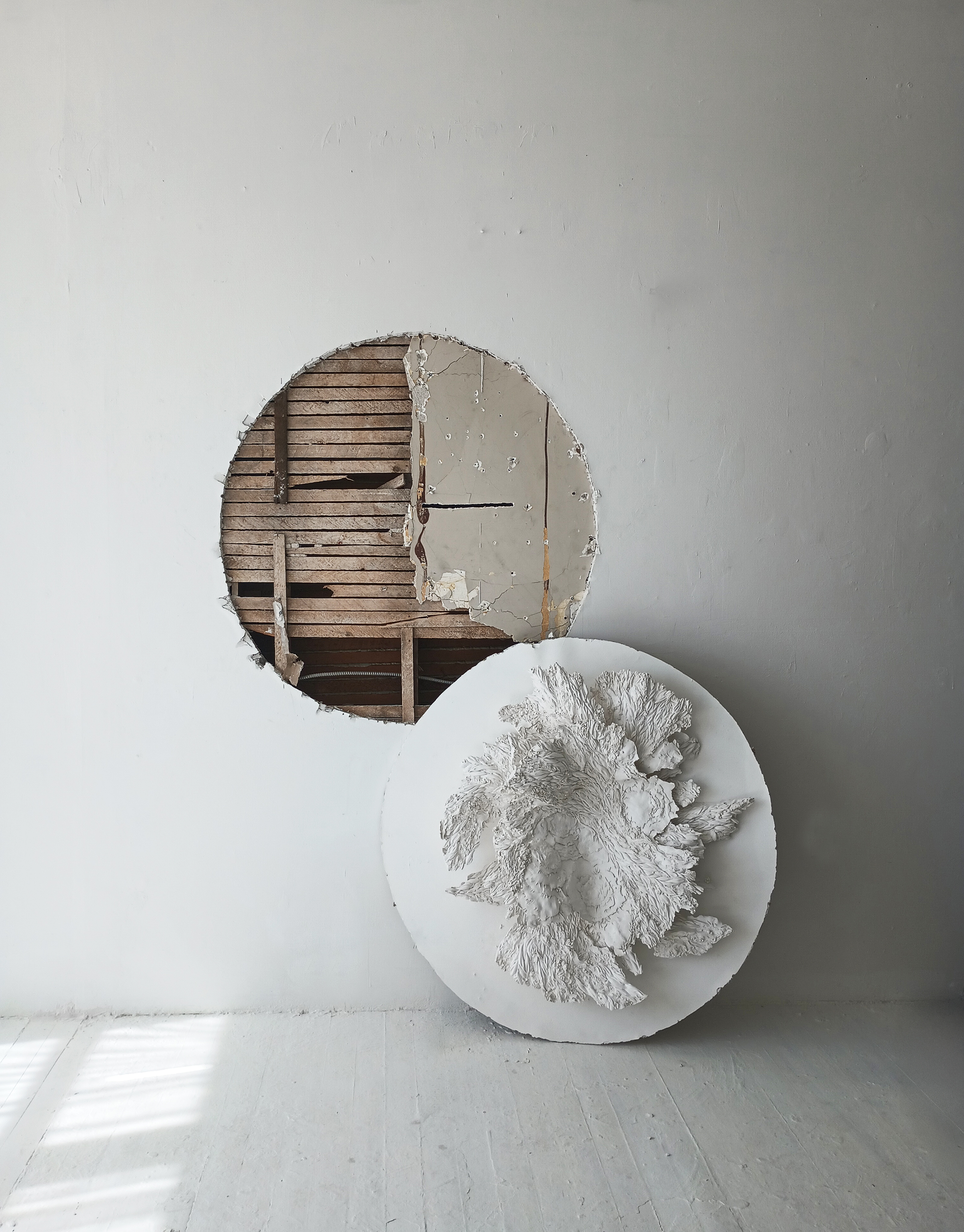 a hole in the studio wall, the drywall used as base for plaster textural form