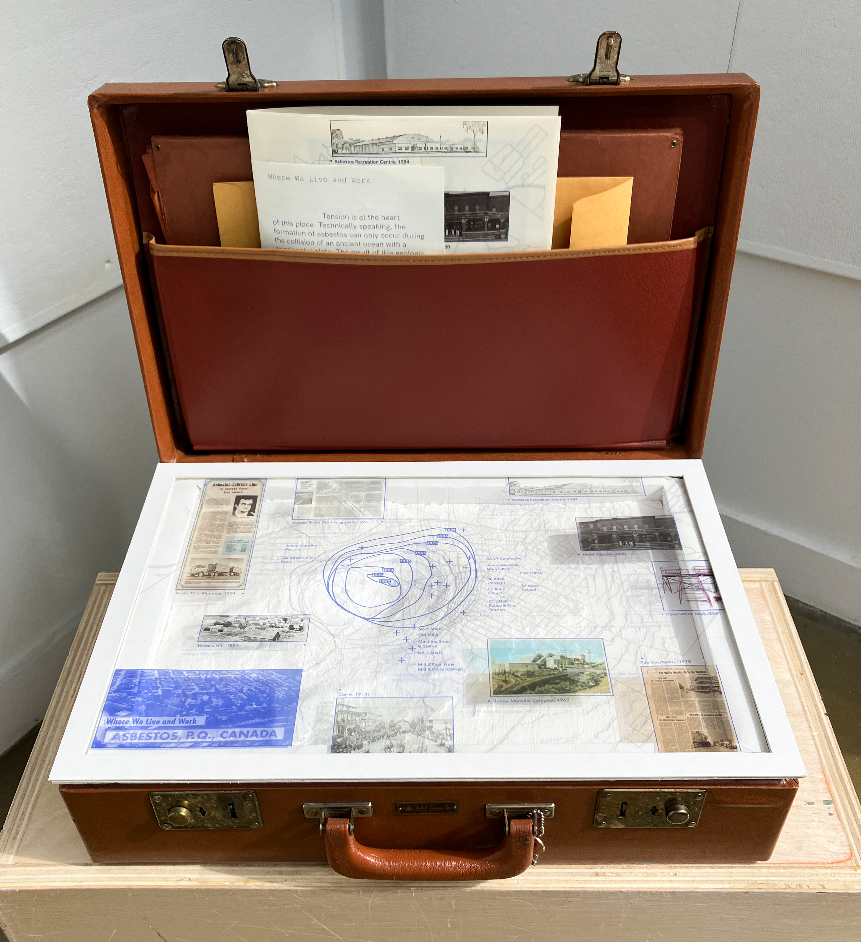 A photograph of the landscape repository which is a briefcase with a CNC model of Val-des-Sources inside, mapping plates that can be placed on top of the model, and narrative atlas booklets.