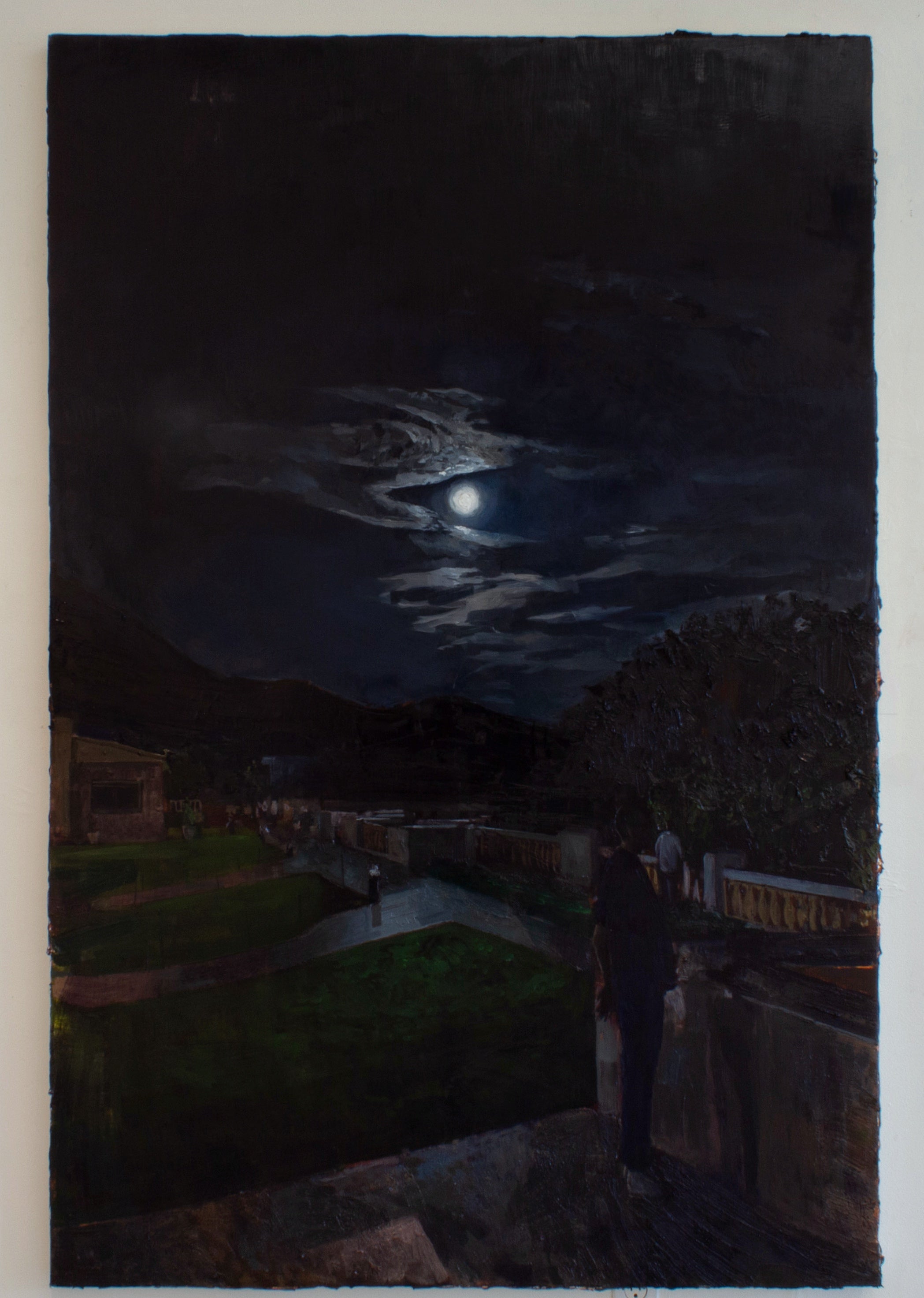 Two figures stand on a terrace on a dark moonlit night