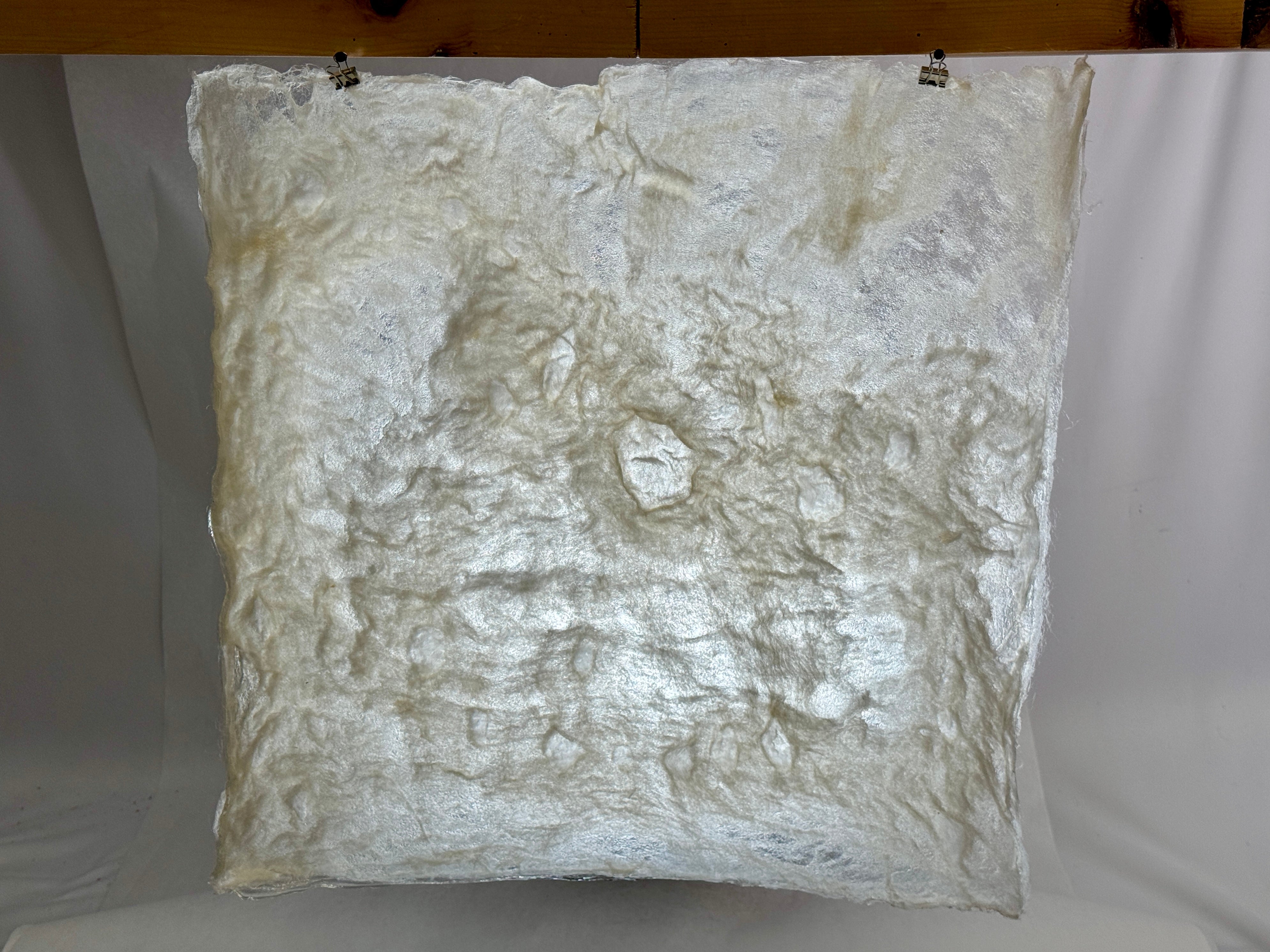 A sheet of material made from a mixture of wool and methylcellulose. 21 inches by 21 inches. The material is nearly opaque, but light can still pass through. This material will be applied to the back of the user’s head in the final “shelter” design to reduce the feeling of being watched by others or having one’s privacy invaded.