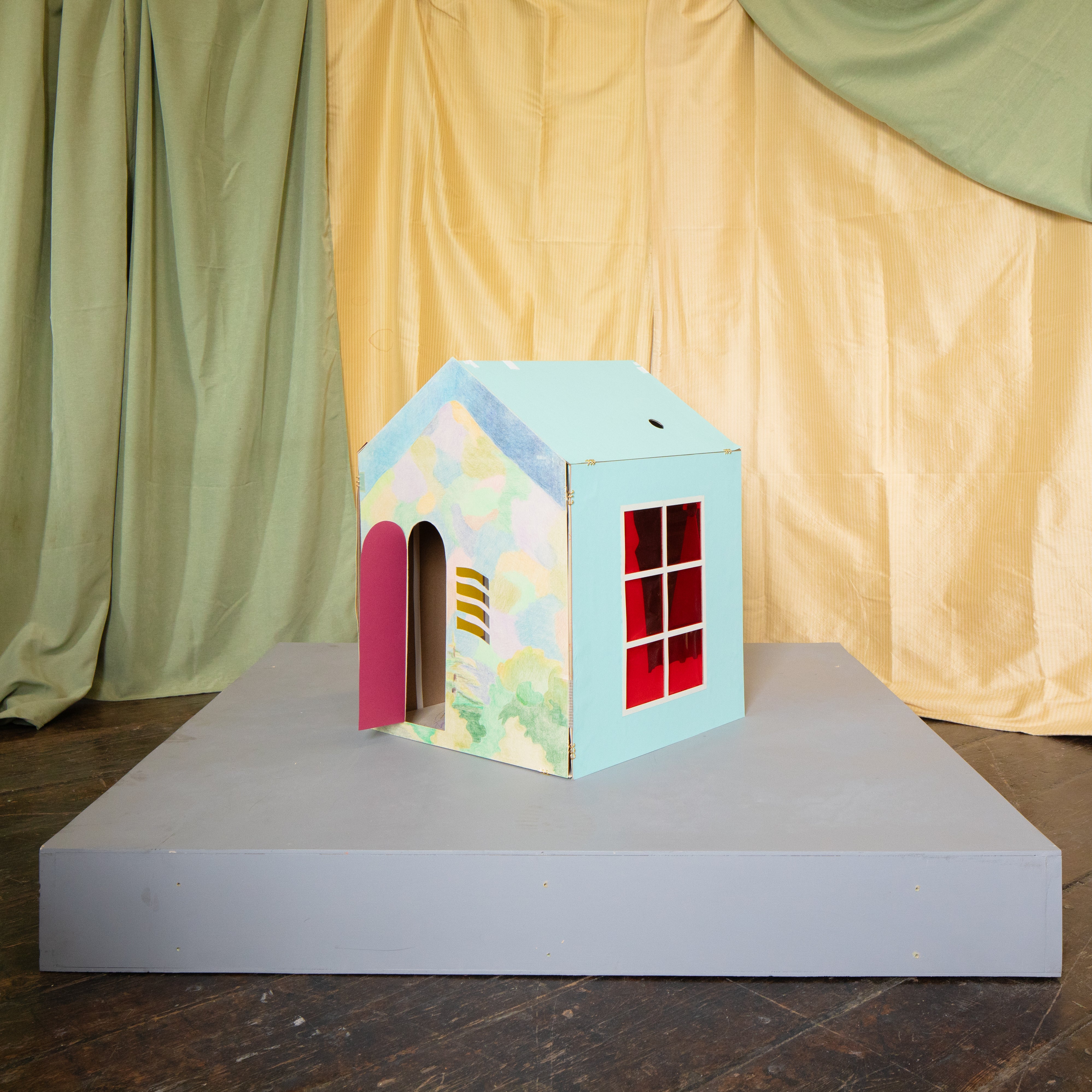 a house form with drawings of the environment as its covering. 