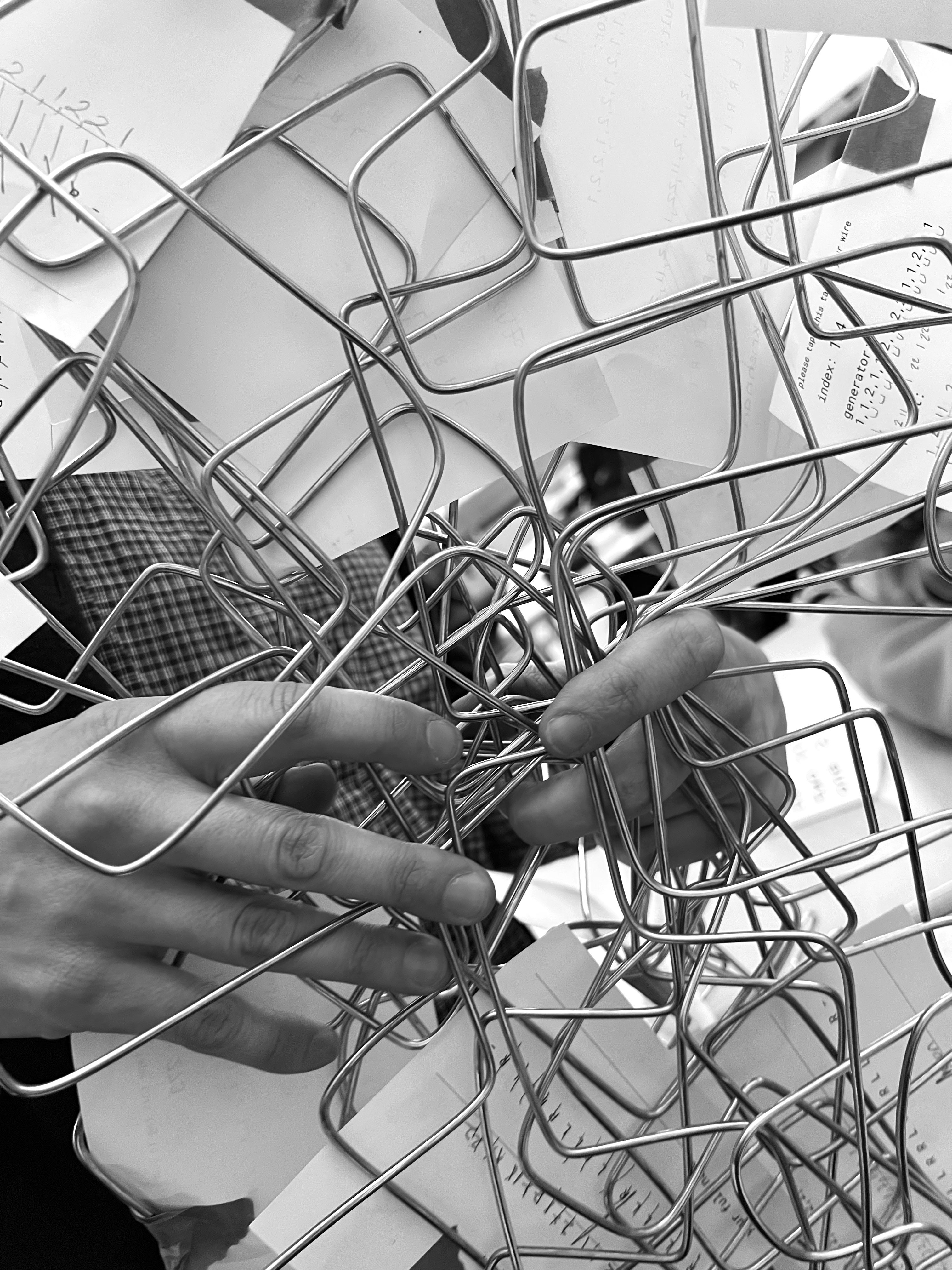 Hands holding folded wires