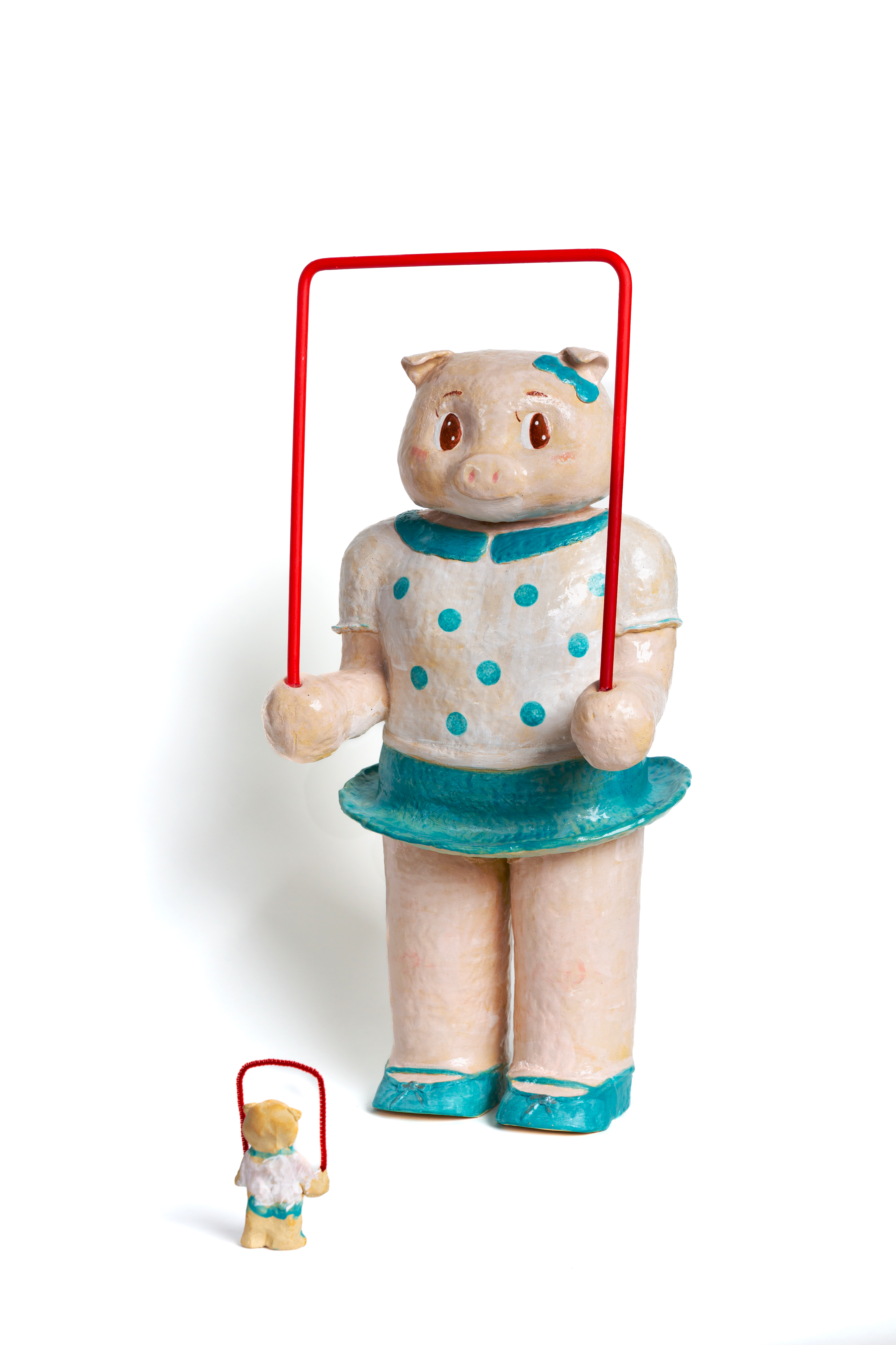 Enlarged jumping rope pig toy. Playful form referencing childhood toy and early cultural exchange.