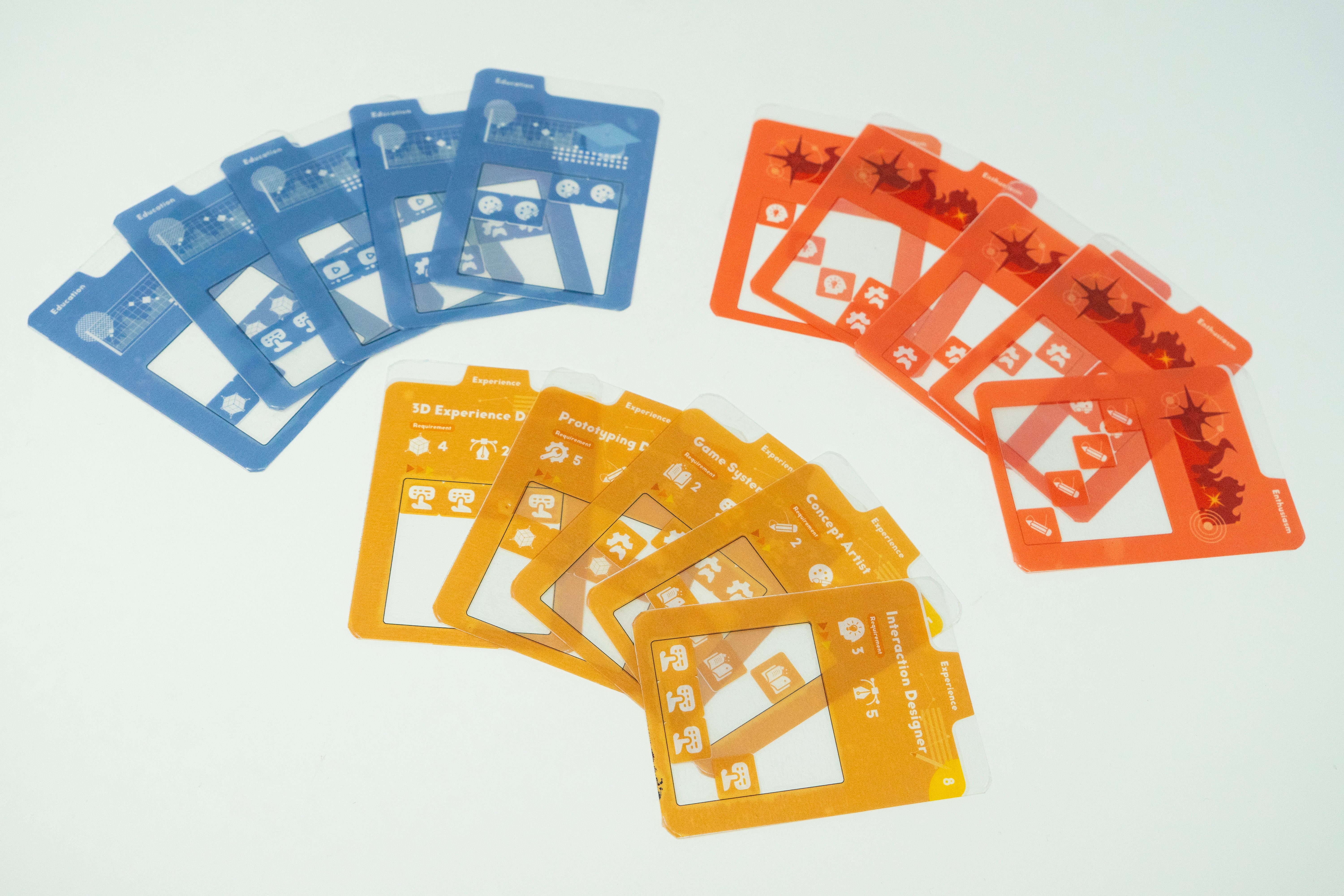 Colorful tabletop card game prototype displaying transparent overlays, modular experience cards, and role cards used for resume-building, storytelling, and persuasive communication gameplay.