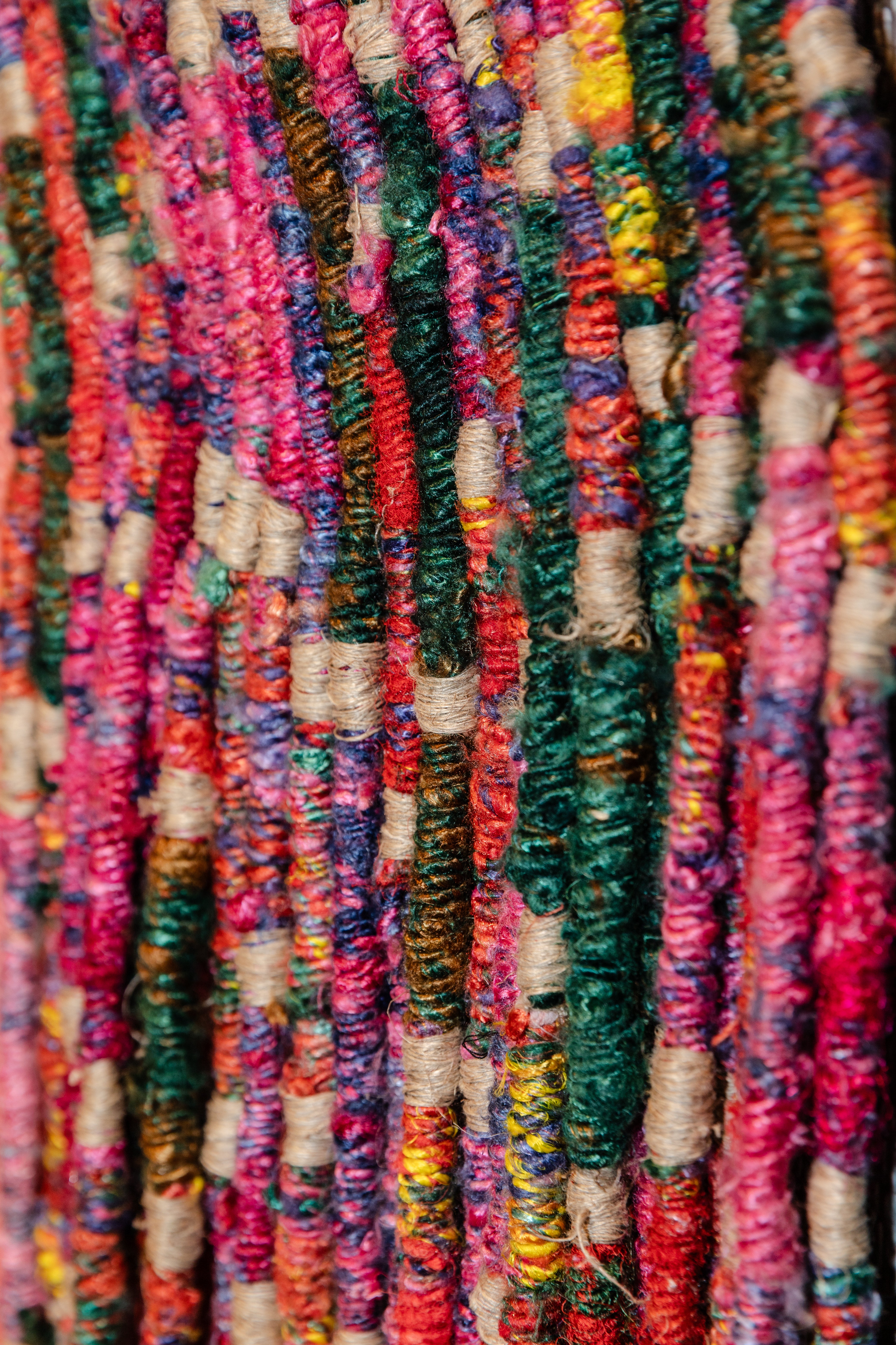 Multi-color recycled saree yarn hand twisted to create a material surface with modular assembly. Title: Parts in circulation
