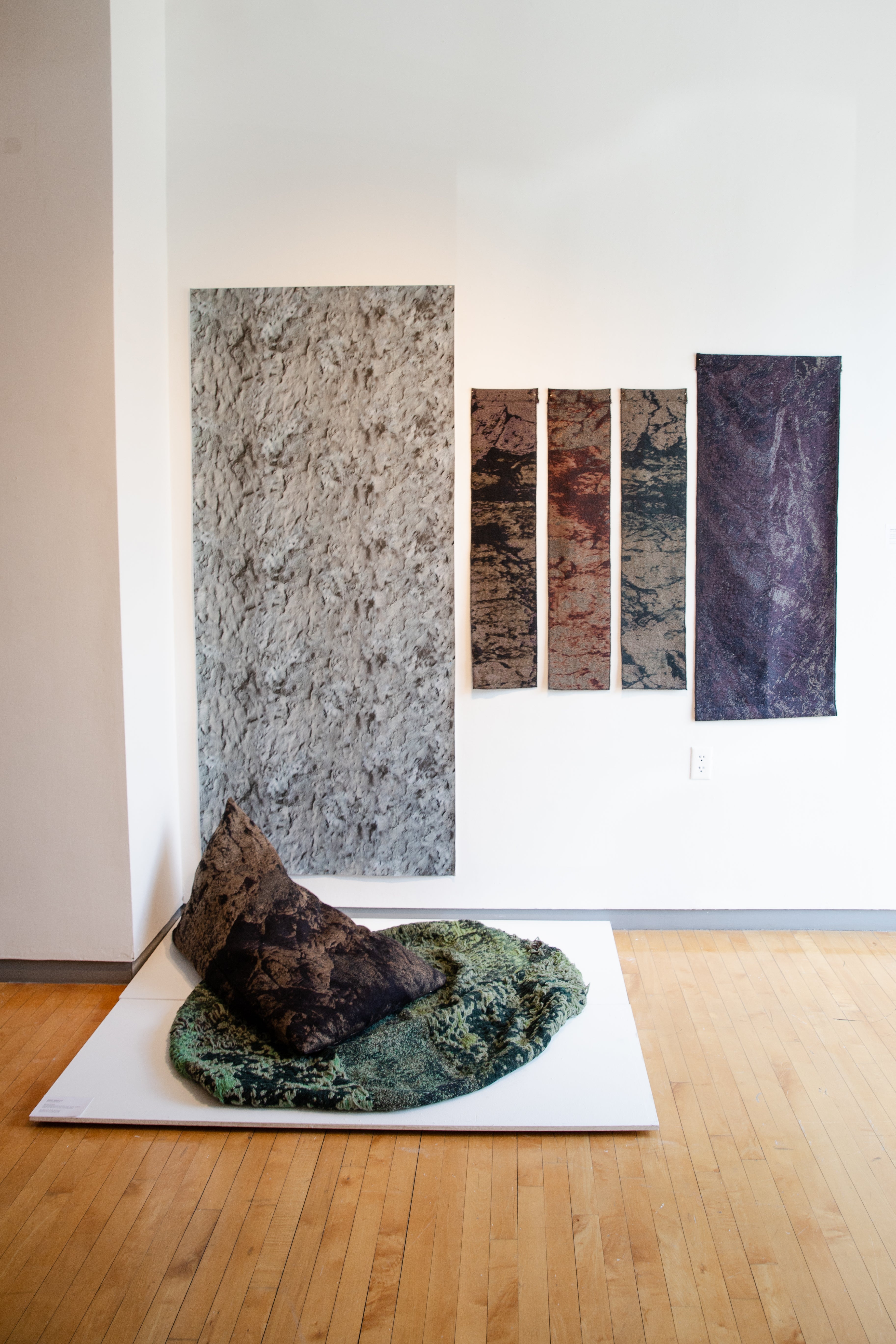 Jacquard woven textiles designed and engineered to simulate different types of rock surfaces. Rock shaped bean bag and fabric lengths. 