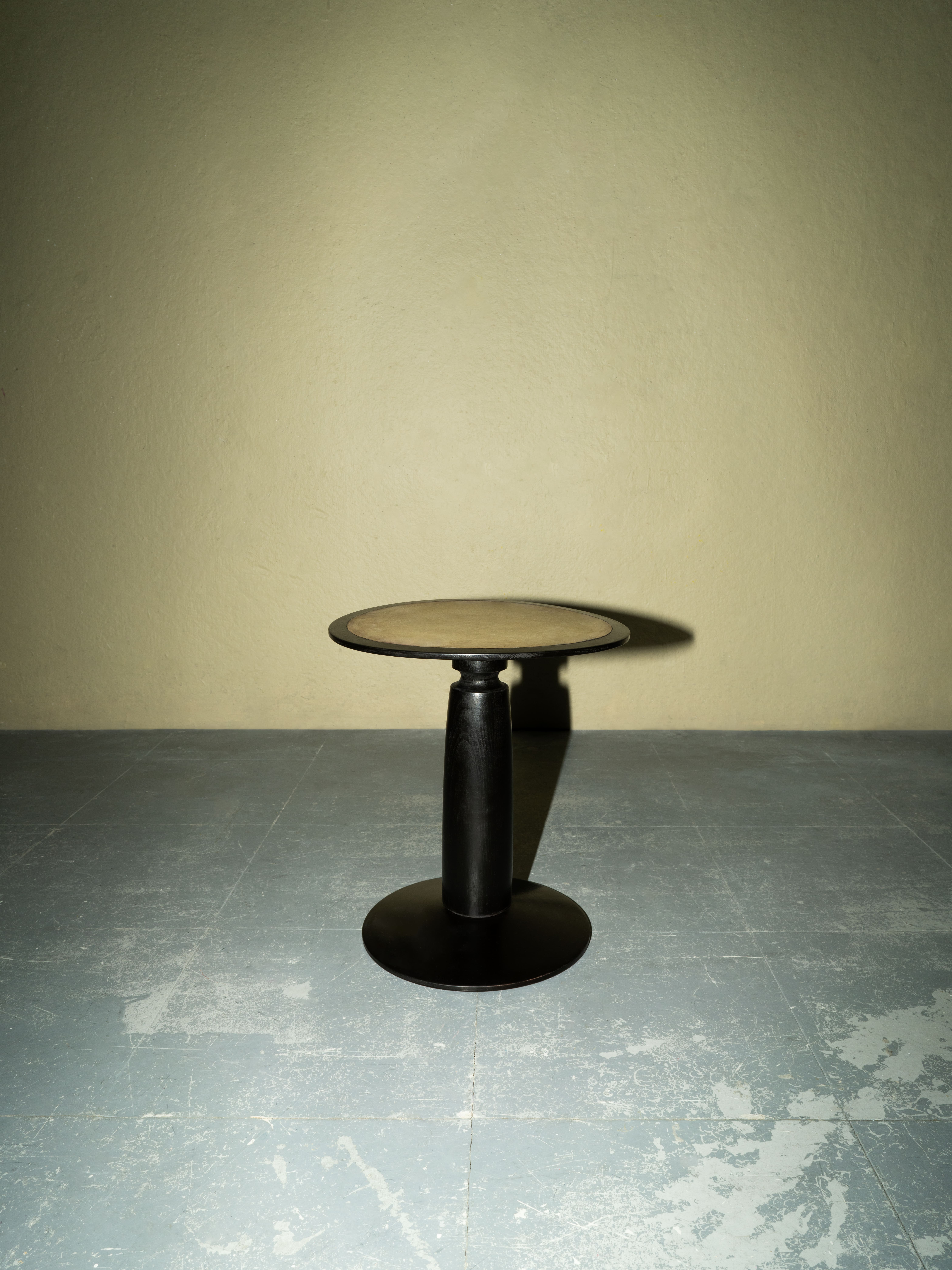A stool with a moon shaped seat. 