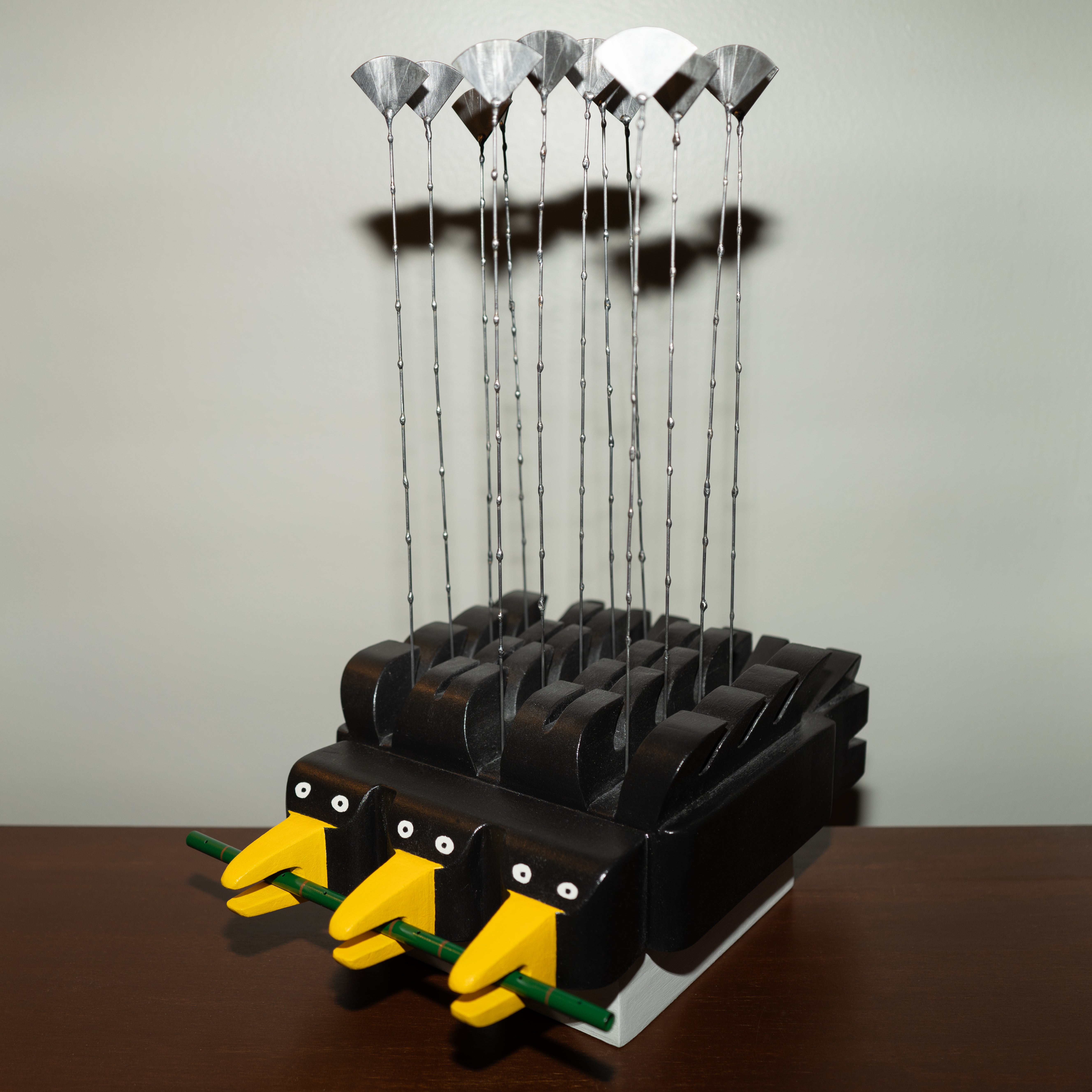 Instrument inspired by crows in Providence. Percussion instrument that produces sound by brushing the steel elements with the hand or a stick.