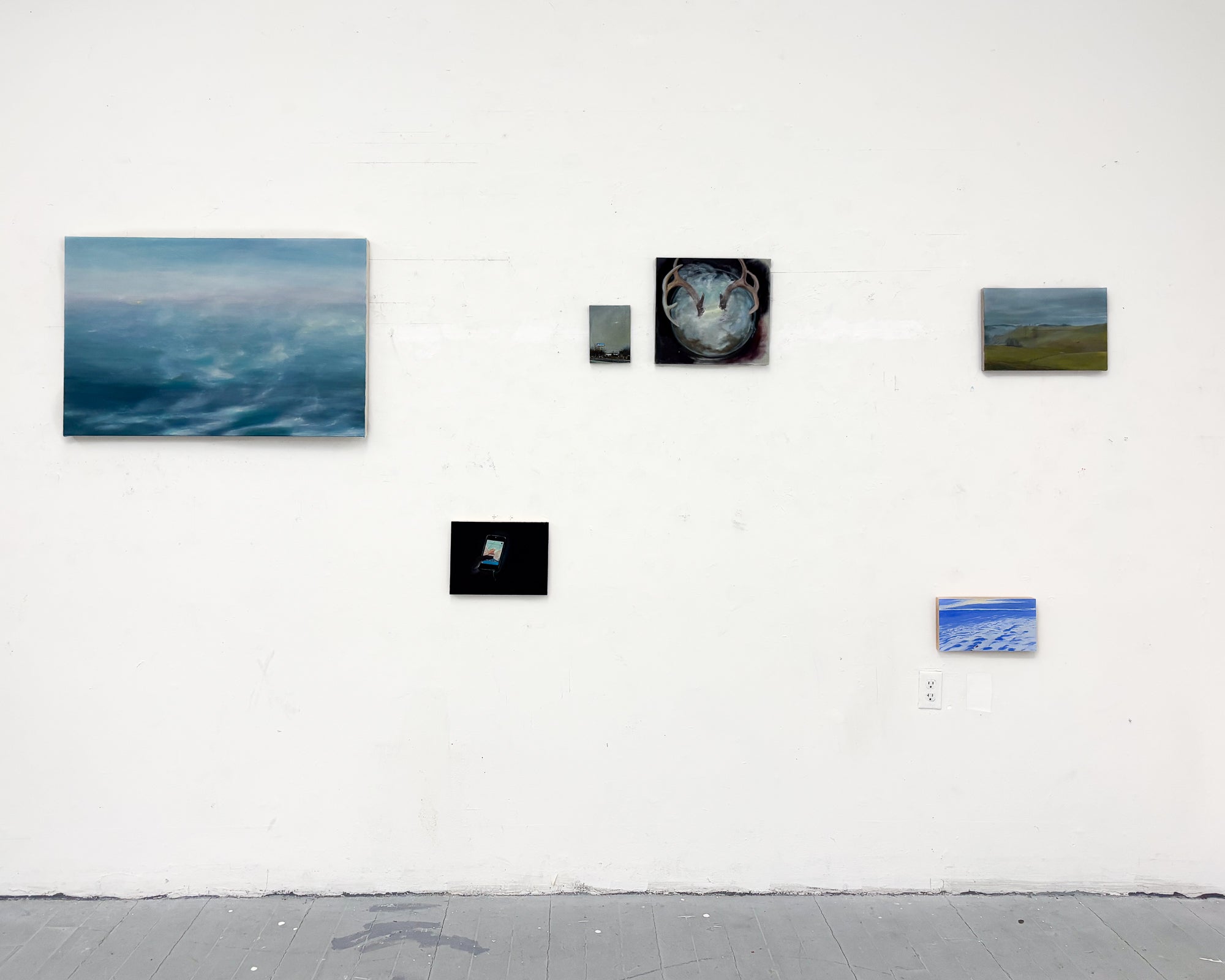 This is an installation shot of a group of 6 paintings, hung at varying heights. 