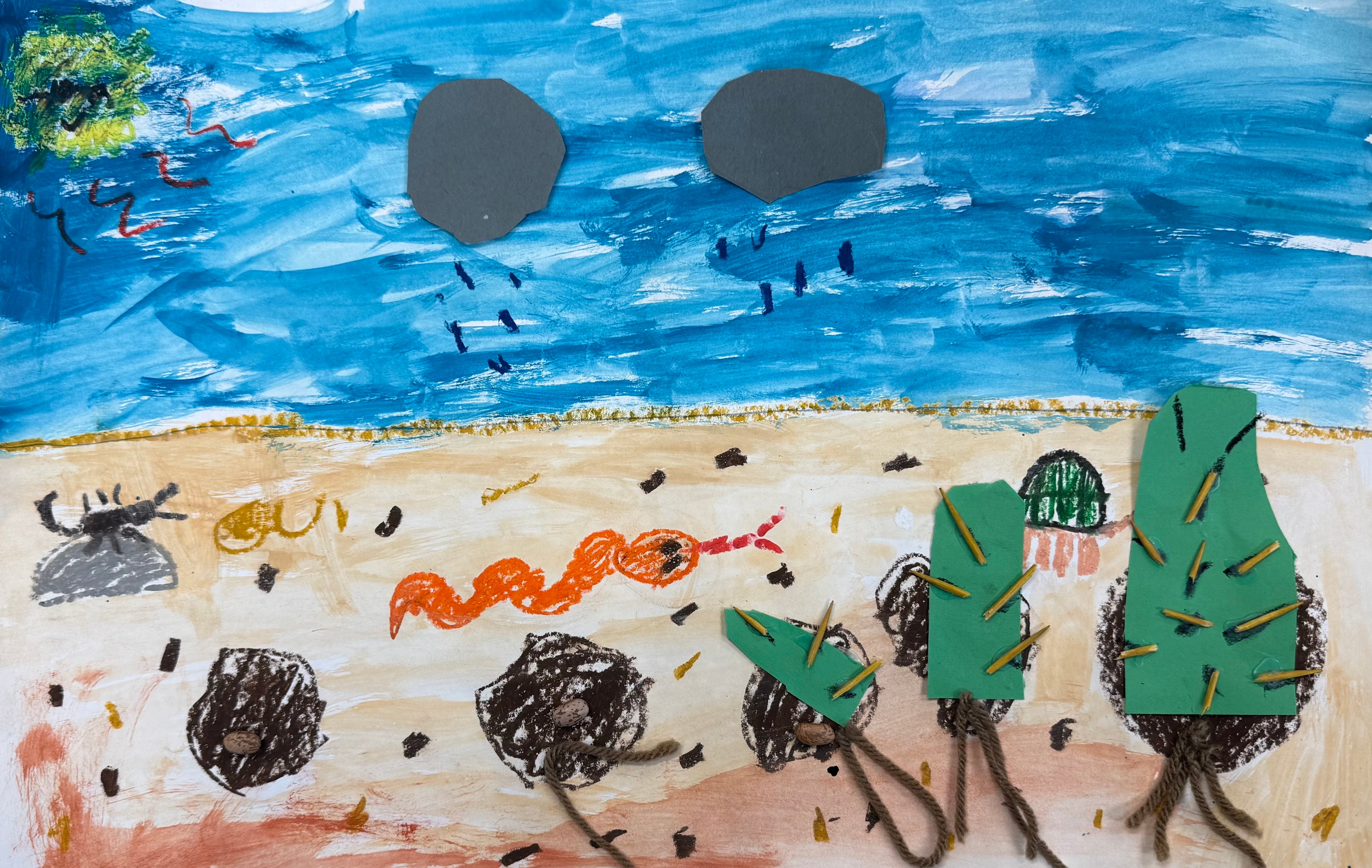 This is a painted/ collaged diagram of the germination cycle of a cactus. It is made of construction paper, toothpicks for the cactus spikes and kidney beans for the seed and yarn for the roots.