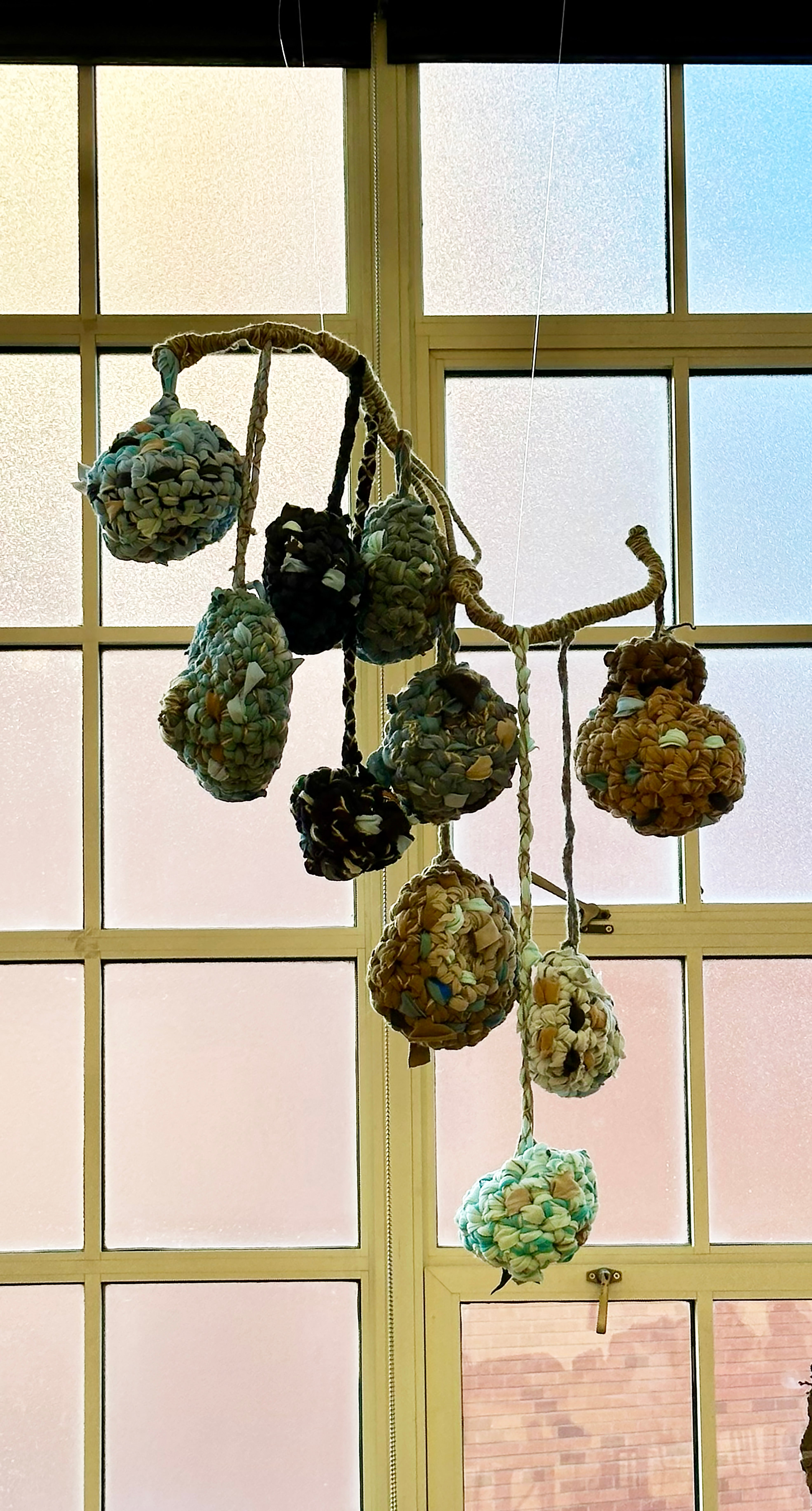 Rest is inspired by weaver bird nest and made with reused materials. Viewers are invited to collaborate with me by putting fabric and yarn scraps inside instead of sending them to the landfill. 