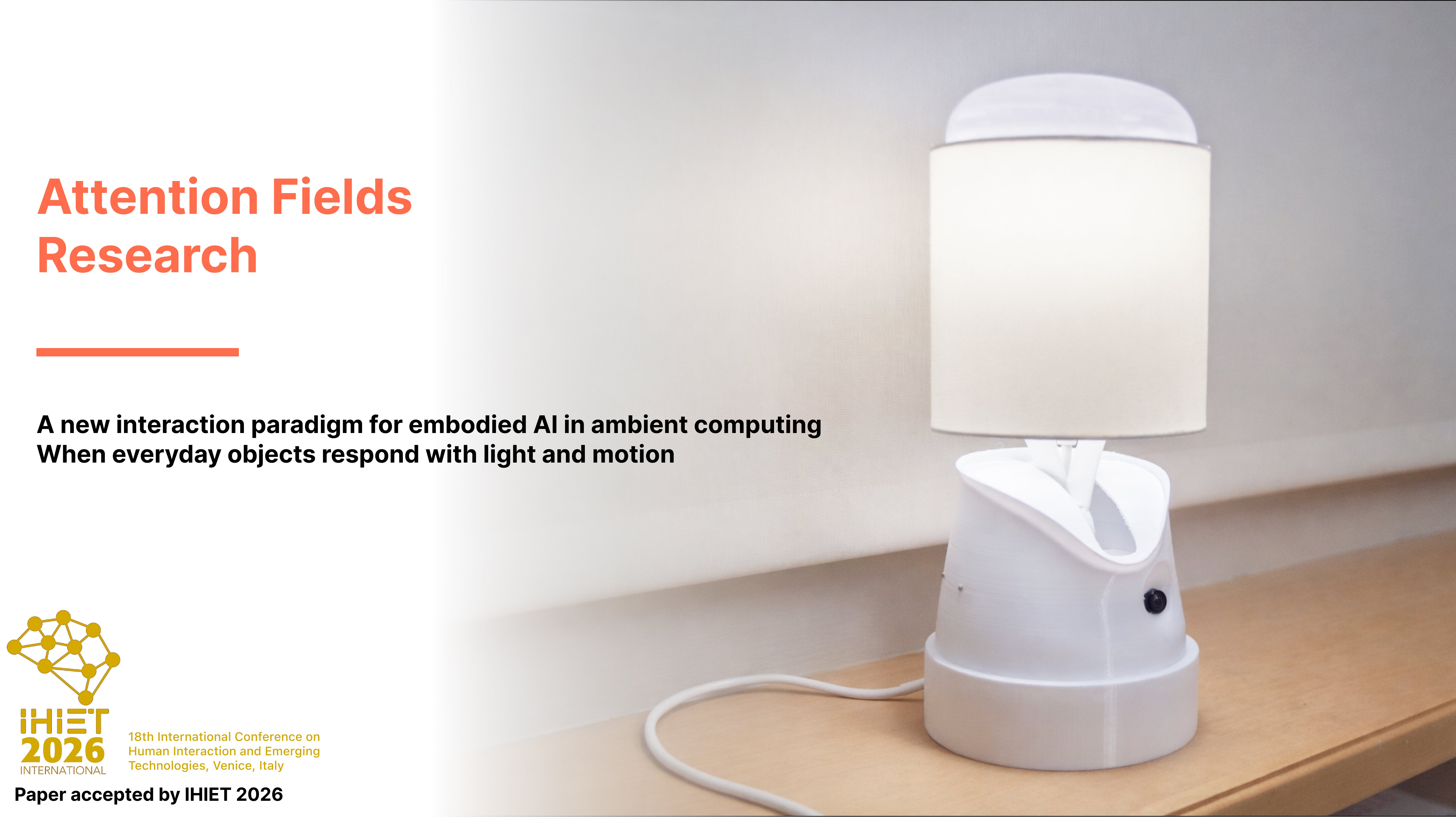 White interactive lamp prototype with a cylindrical fabric shade displayed on a wooden surface against a soft neutral background, representing embodied AI and ambient interaction research.