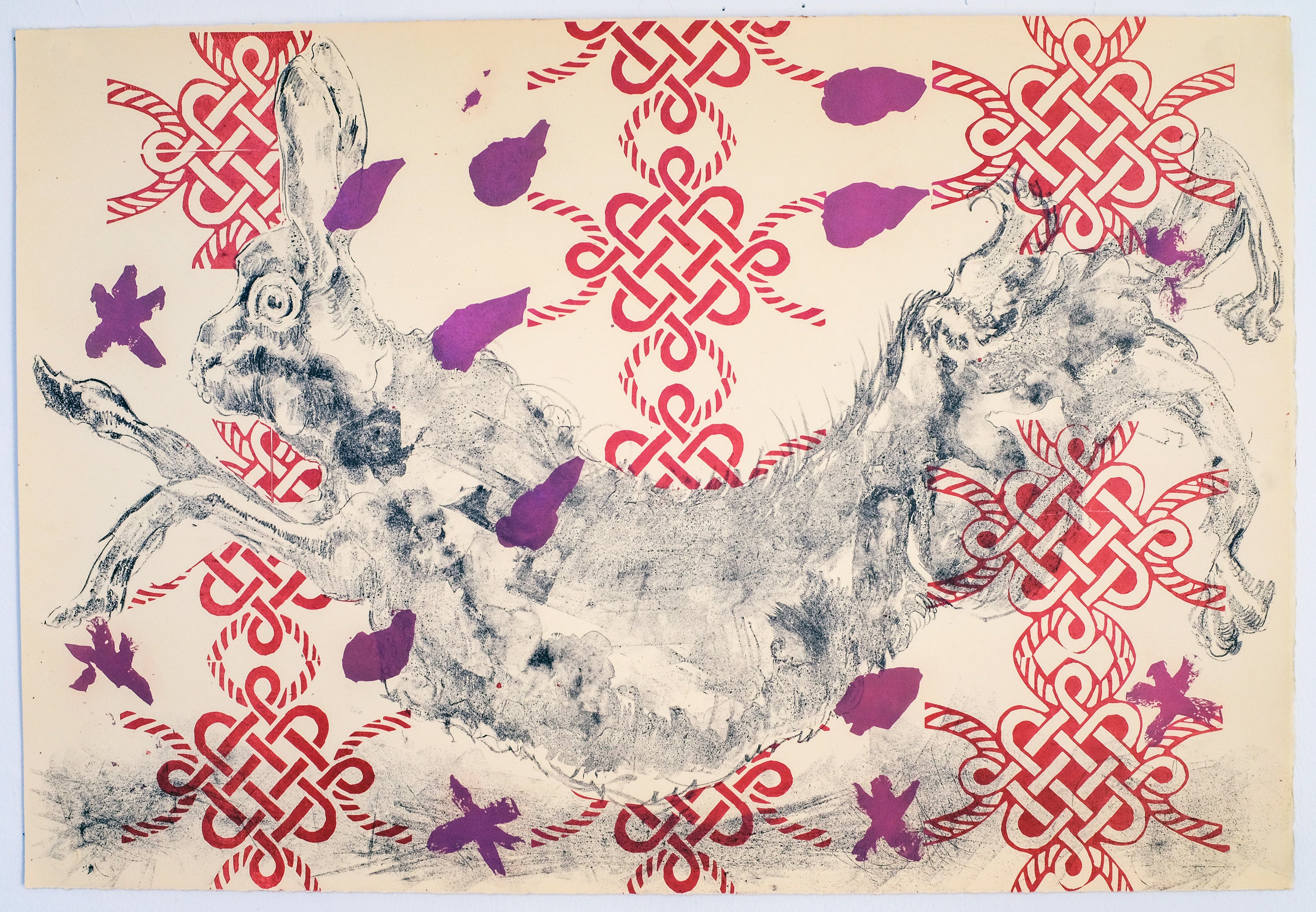 Jumping rabbit against a pattern of red knots and purple flower petals.