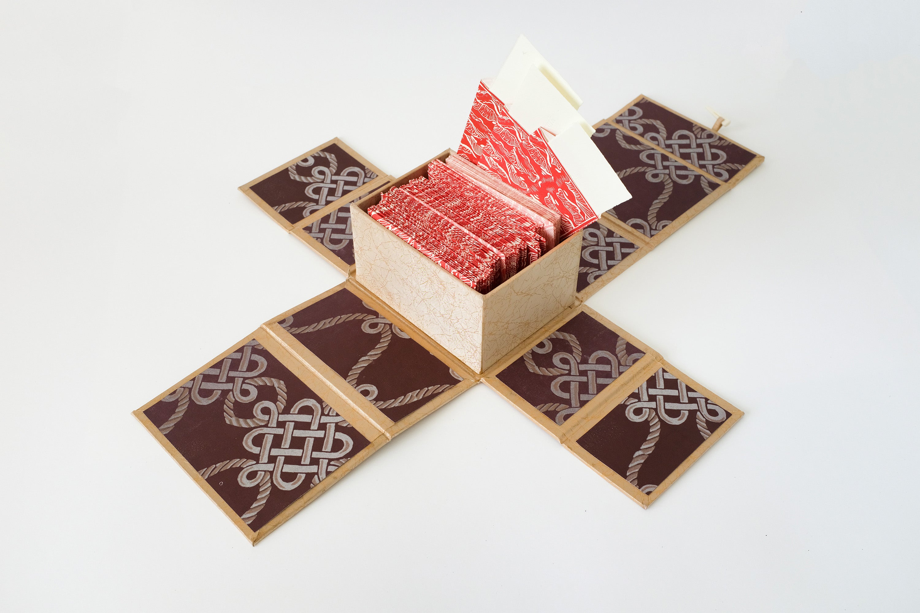 An open box against a white background containing red envelopes. Three envelopes are open and reveal slips of paper inside.