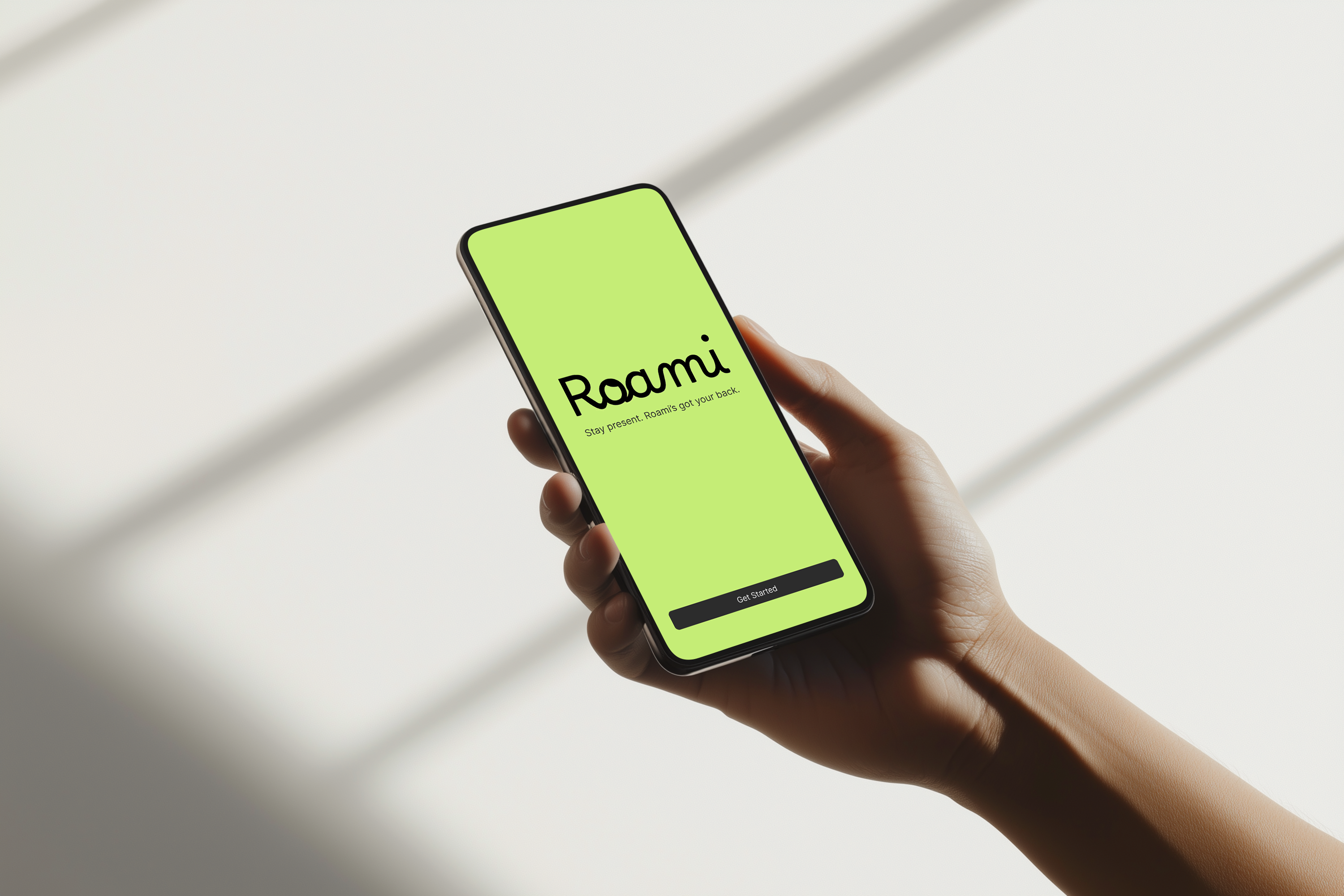 Minimal green landing screen for Roami AI showing logo, tagline “Stay present. Roami’s got your back,” and a single “Get Started” button, designed to feel calm, simple, and welcoming.