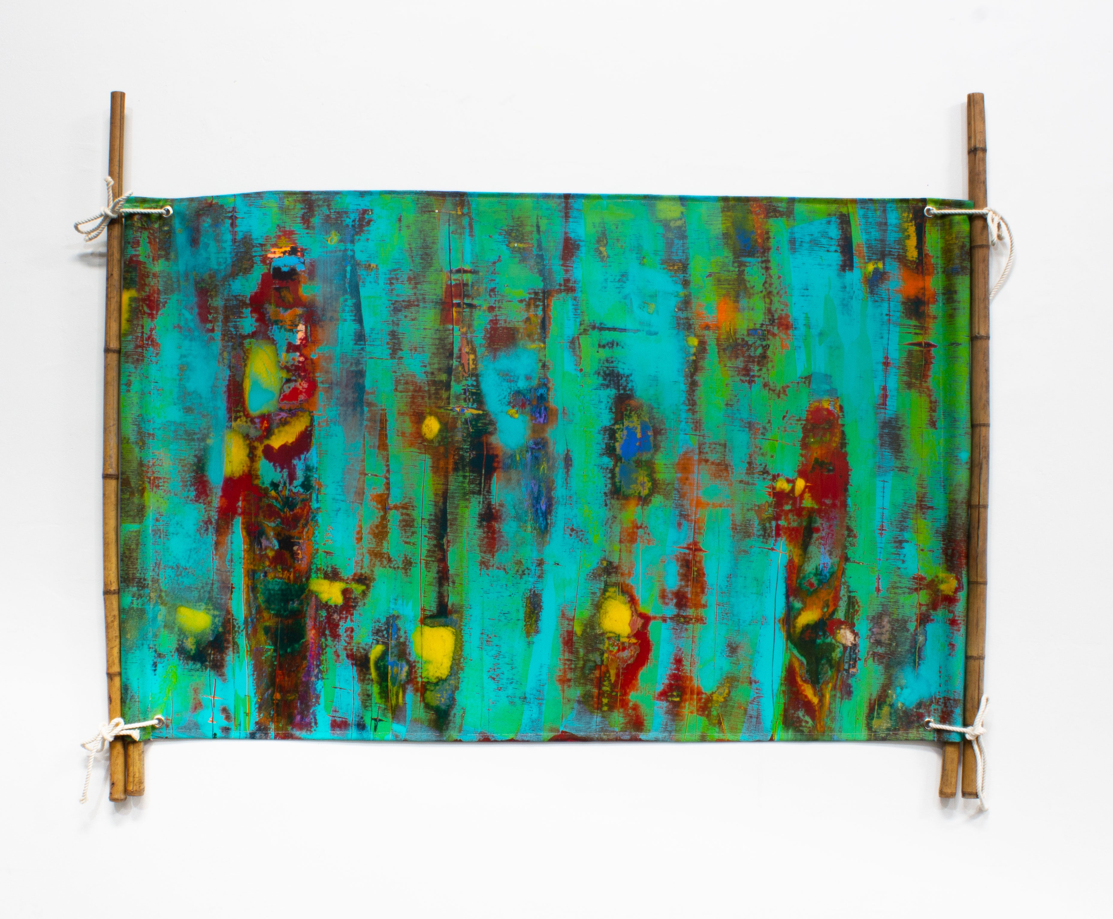 This work represents a painted canvas stitched in a form of wedding tent. attached and hung through bamboo and ropes. 