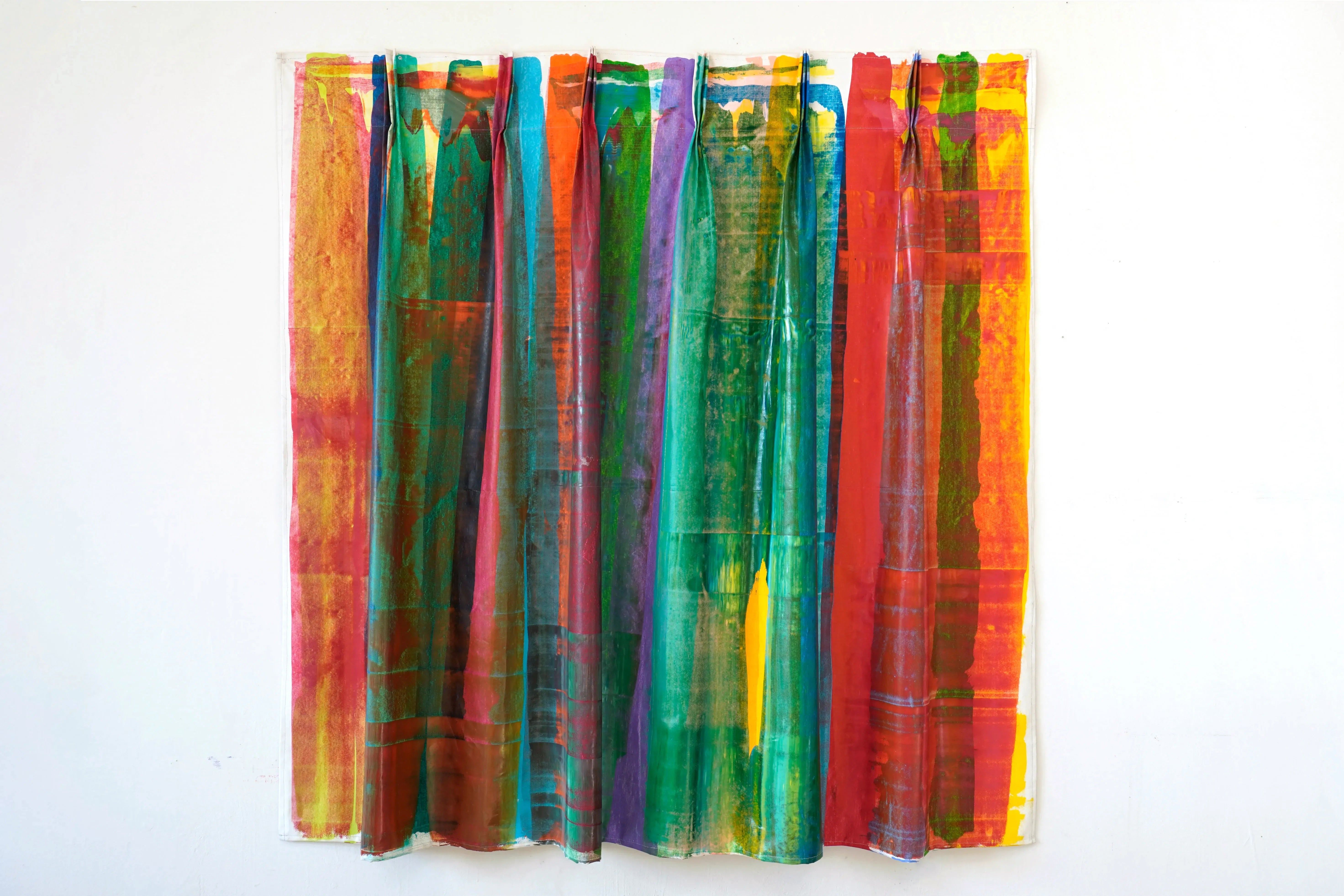This artwork is a stitched canvas in a curtain format. shows multicolor streaks, layered on top of each other.