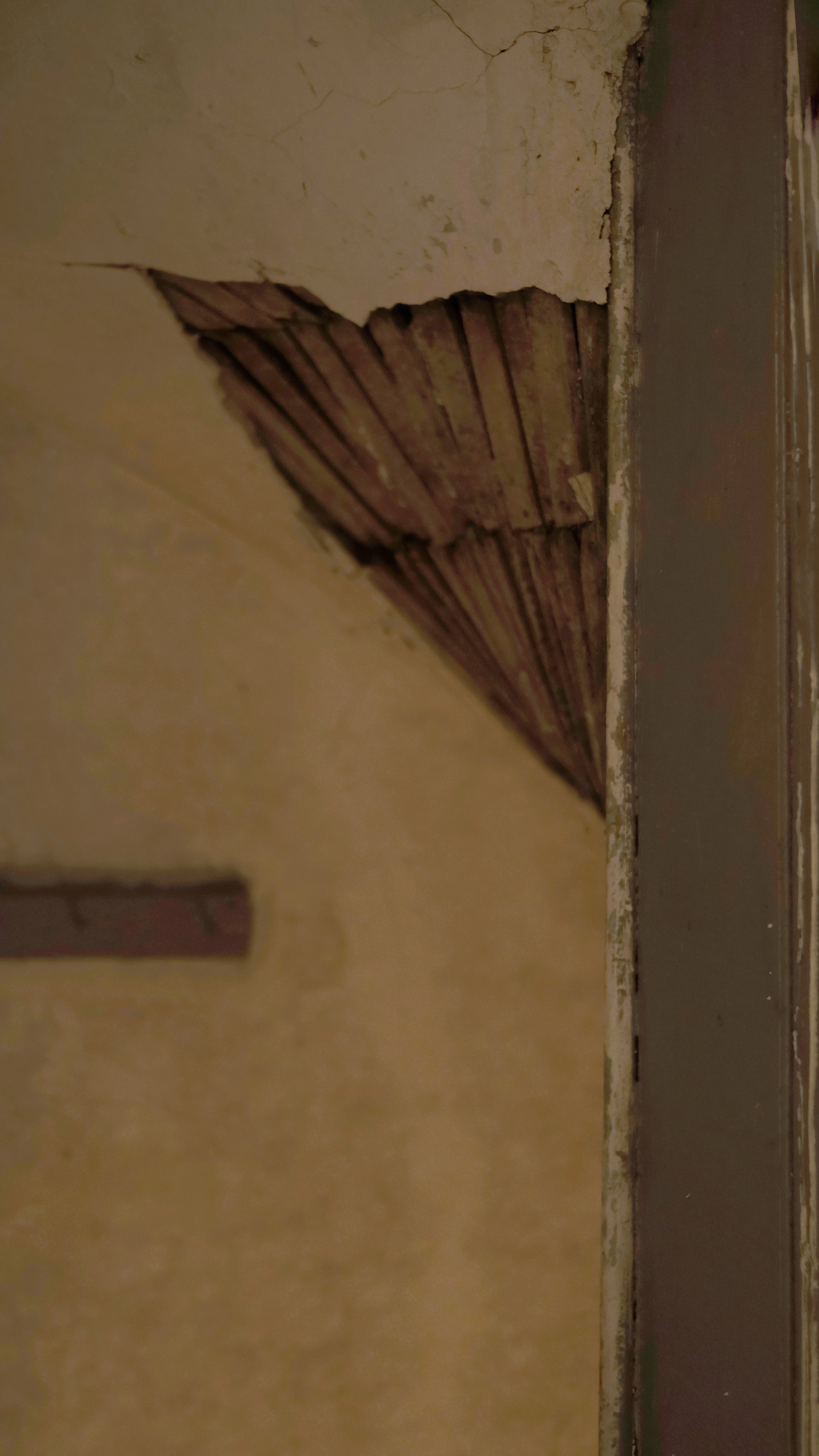 Exposed lathing, revealing the layered construction of a historic Providence building.