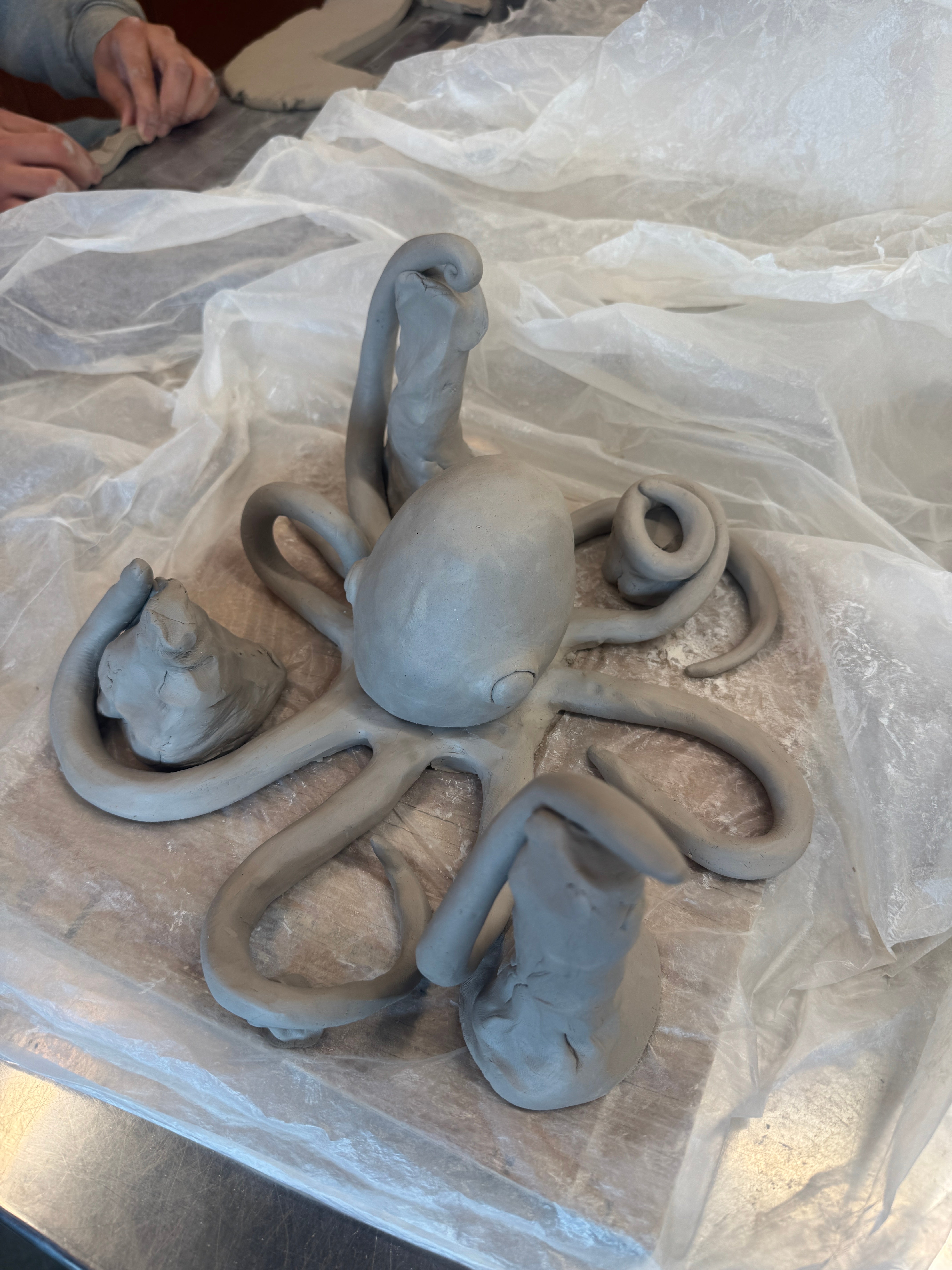 A student out of frame carves an octopus to be able to hold and display medals and other sports awards