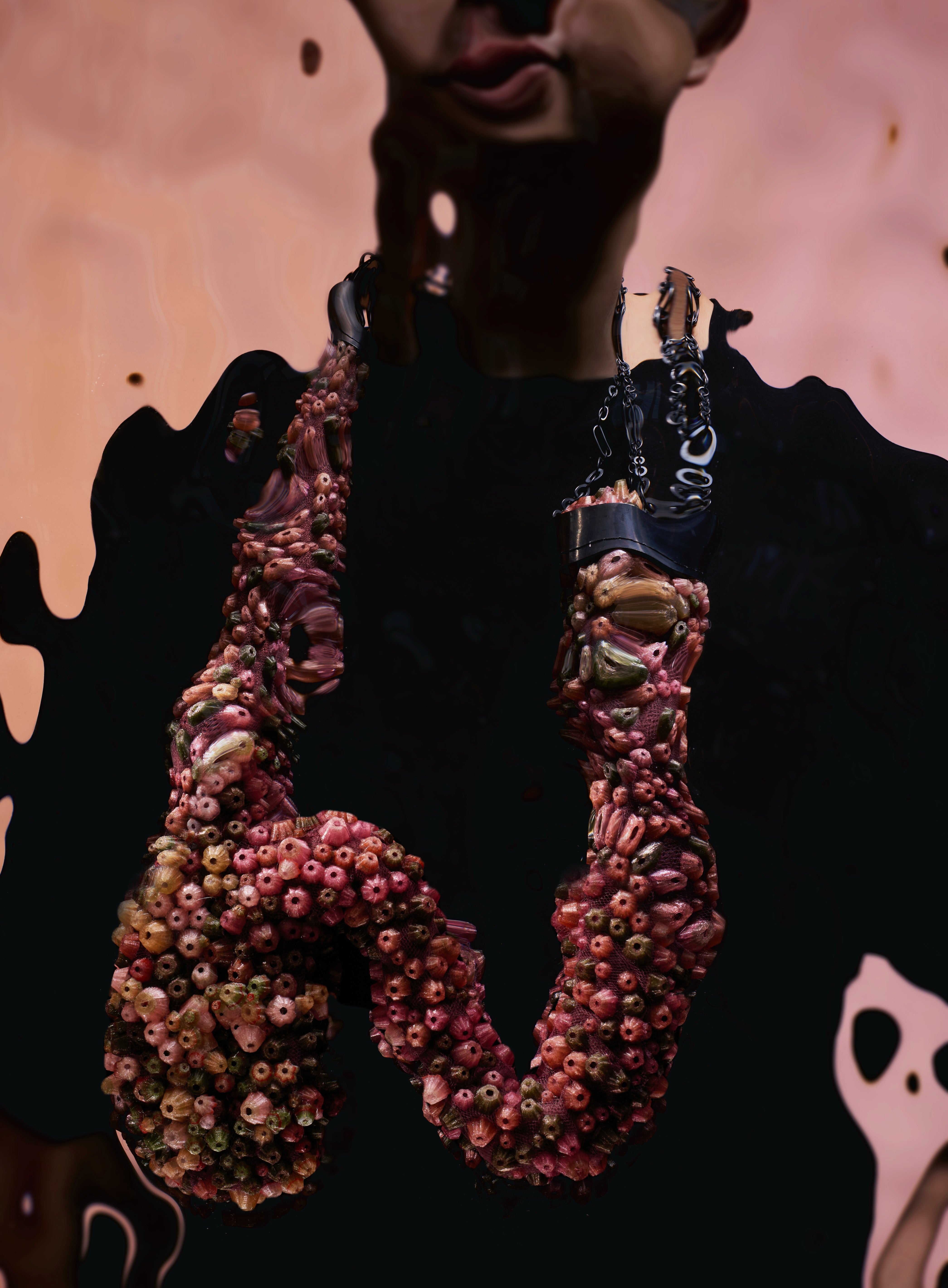 Large necklace covered in dense pink, green, and beige clustered forms on mesh, with an oxidized silver chain wrapping the upper section.