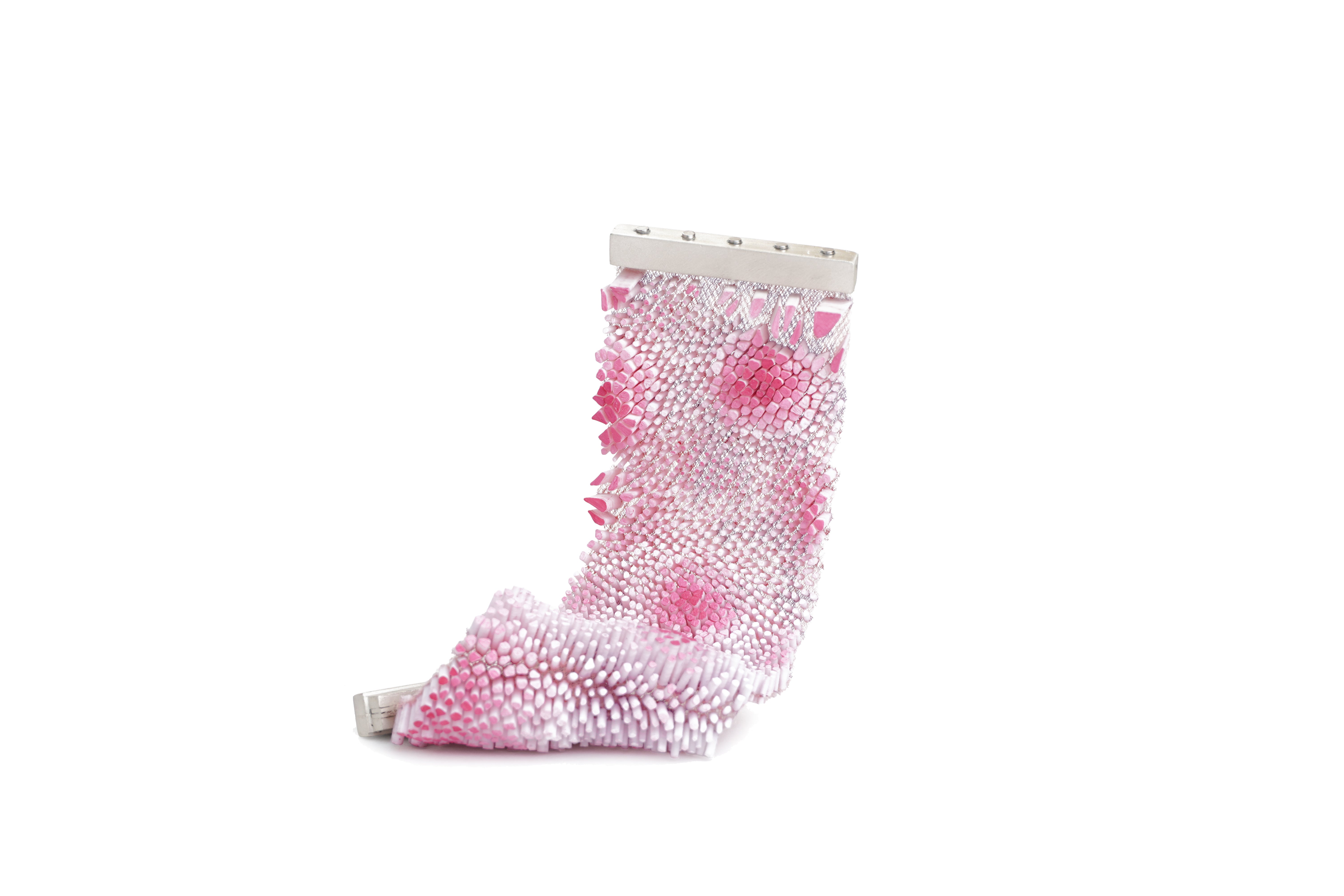 Pink bracelet covered in densely packed small upright elements on mesh, with darker pink areas creating depth variation.