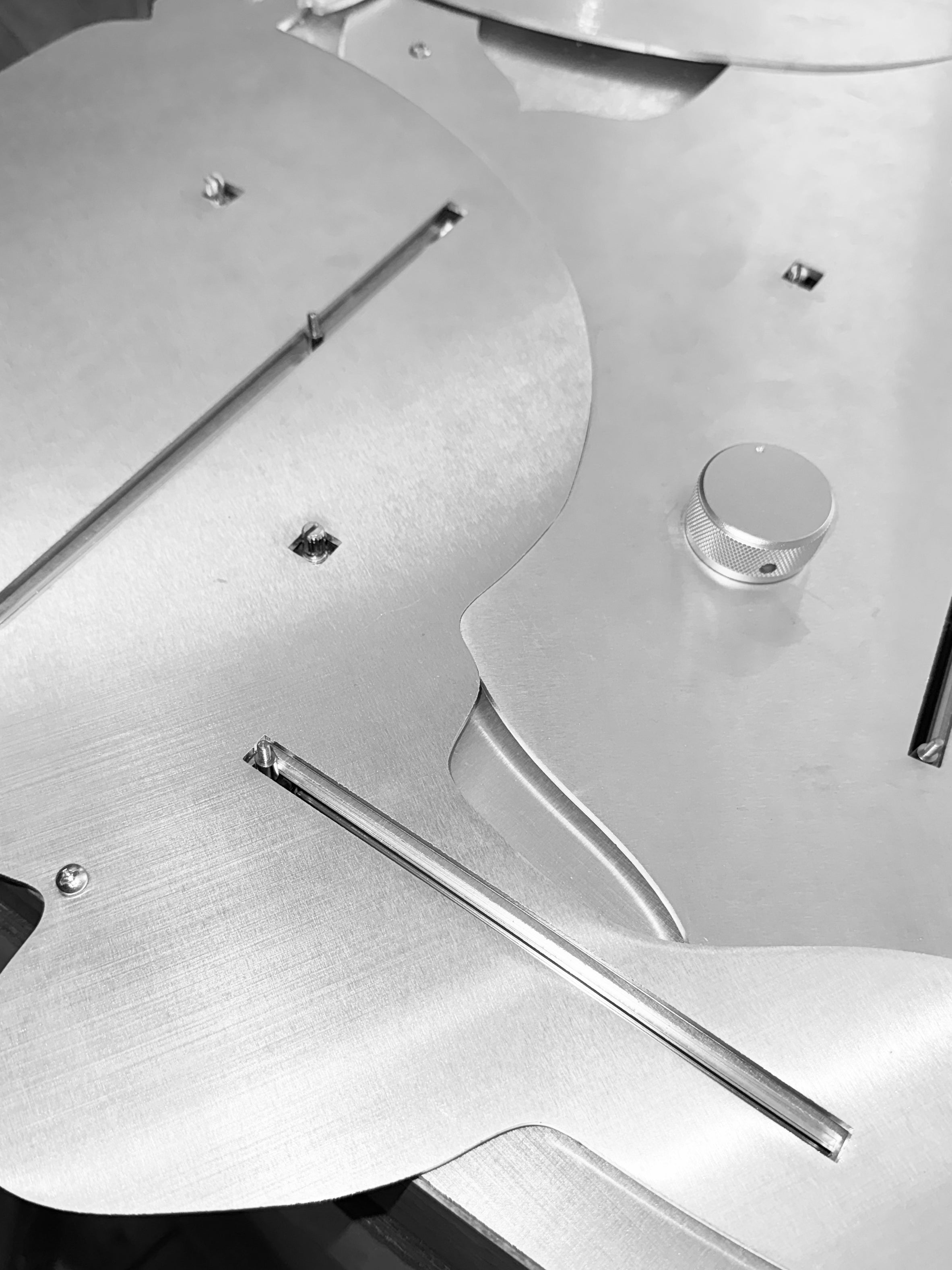 Close-up of a custom aluminum control panel with sliders and knobs, designed for an interactive installation that alters spatial and visual conditions through continuous adjustment.