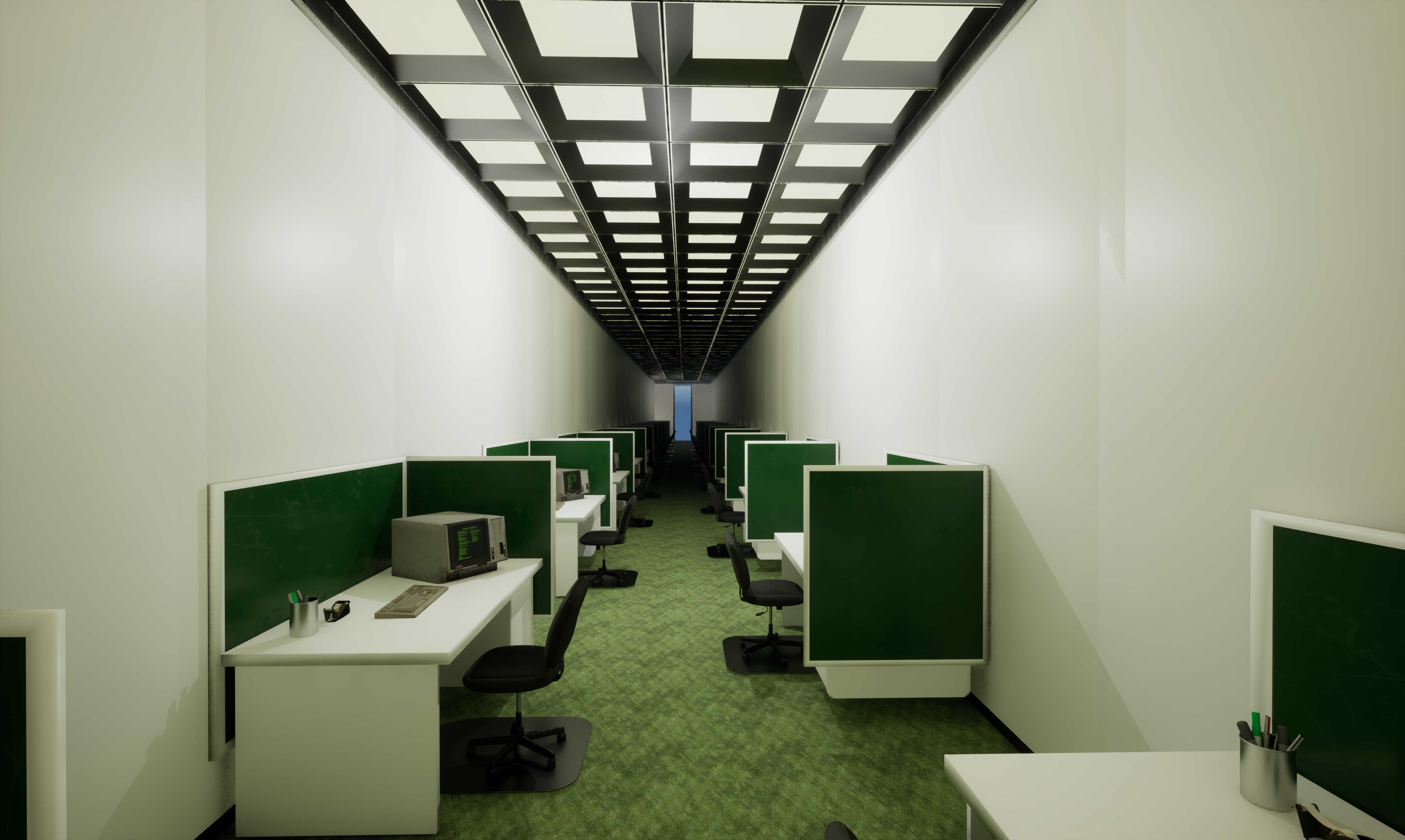 A long, narrow office with rows of green cubicles, desks and chairs, old computers, and bright ceiling lights leading toward a distant doorway.