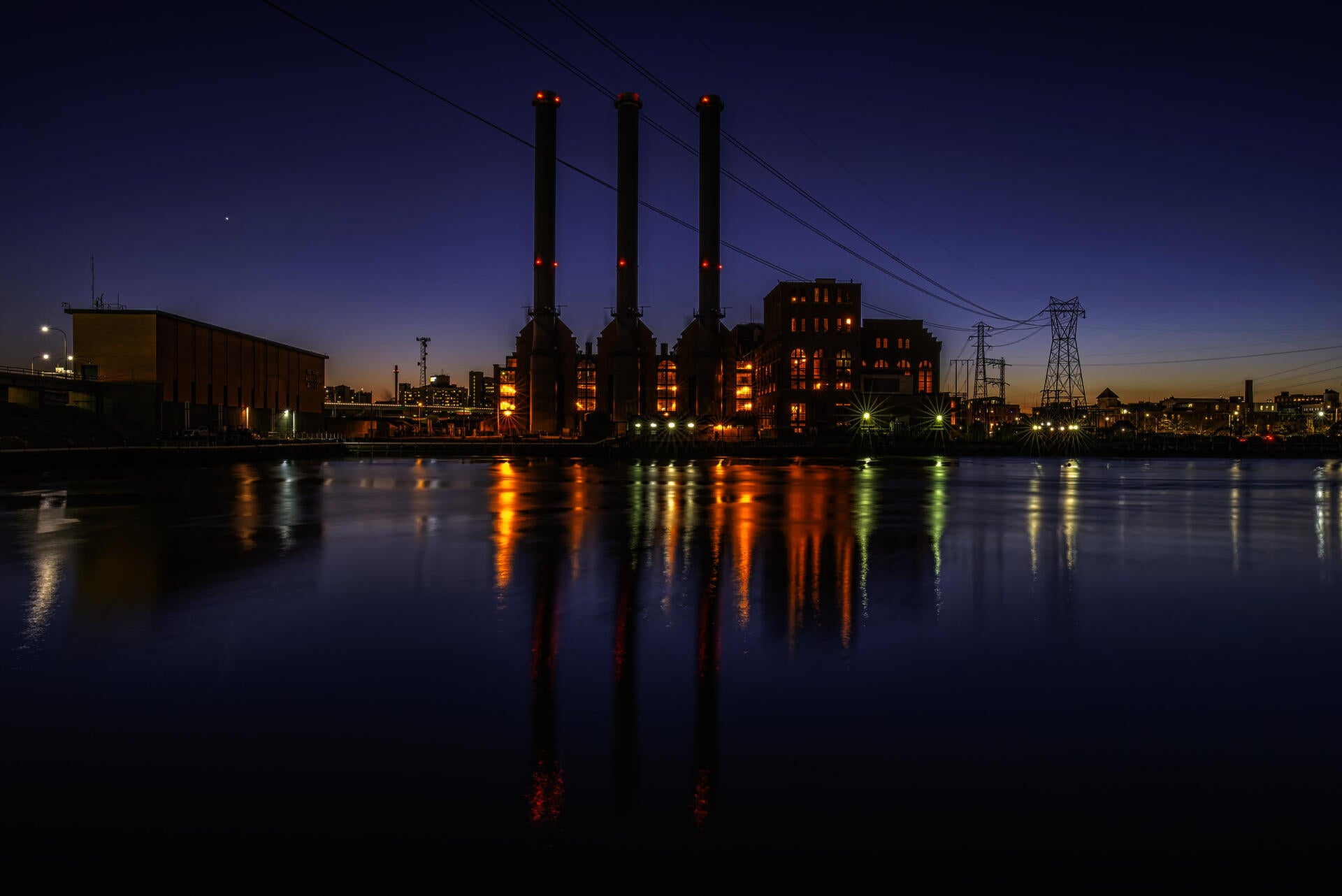 The three smokestacks of the Manchester Street power station at dusk