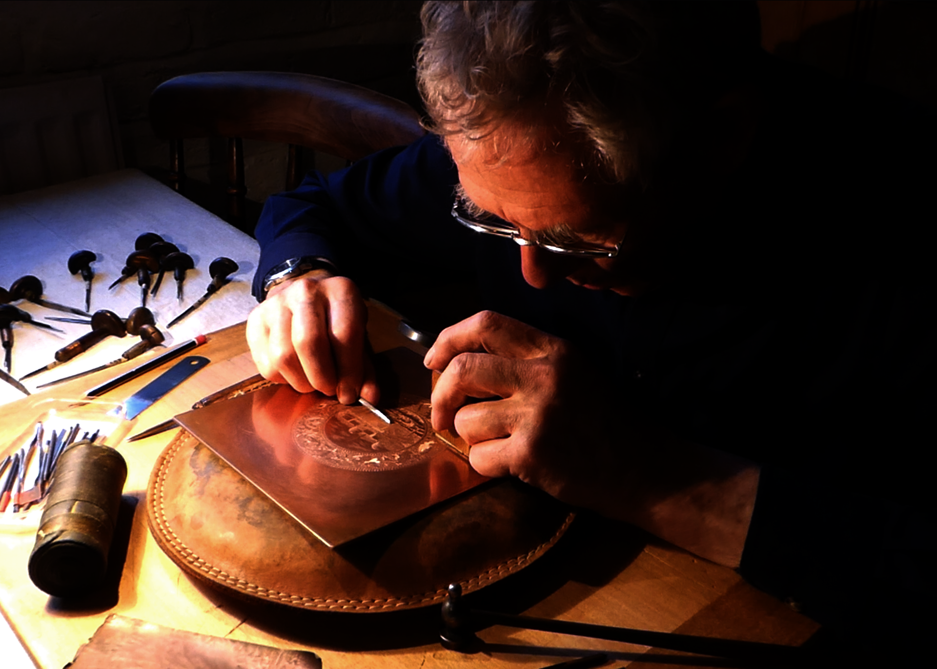 Paul Holdway engraving a copper plate