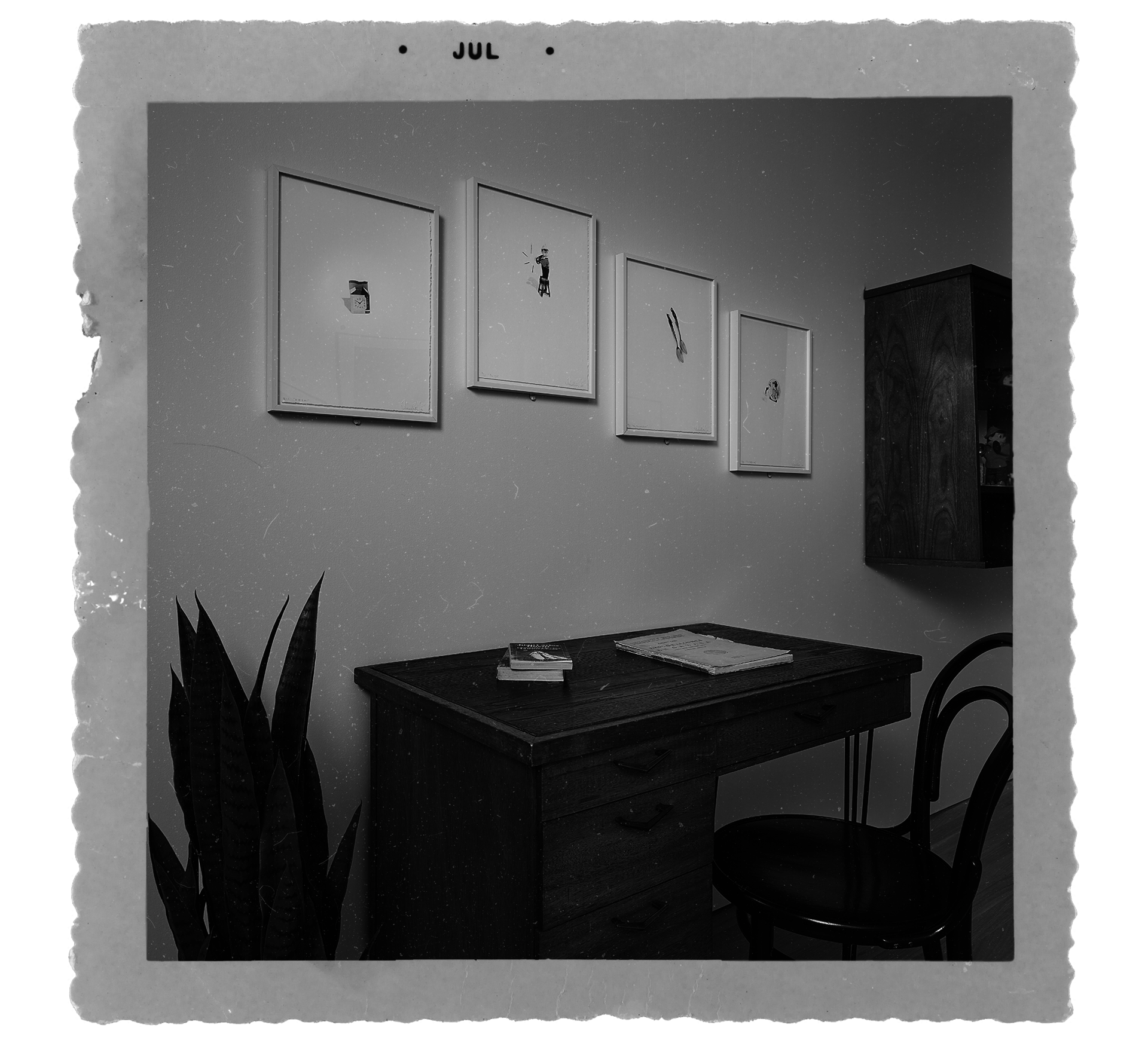 "Old" photograph of three photo-litho prints by Liliana Porter hanging on a wall above a desk
