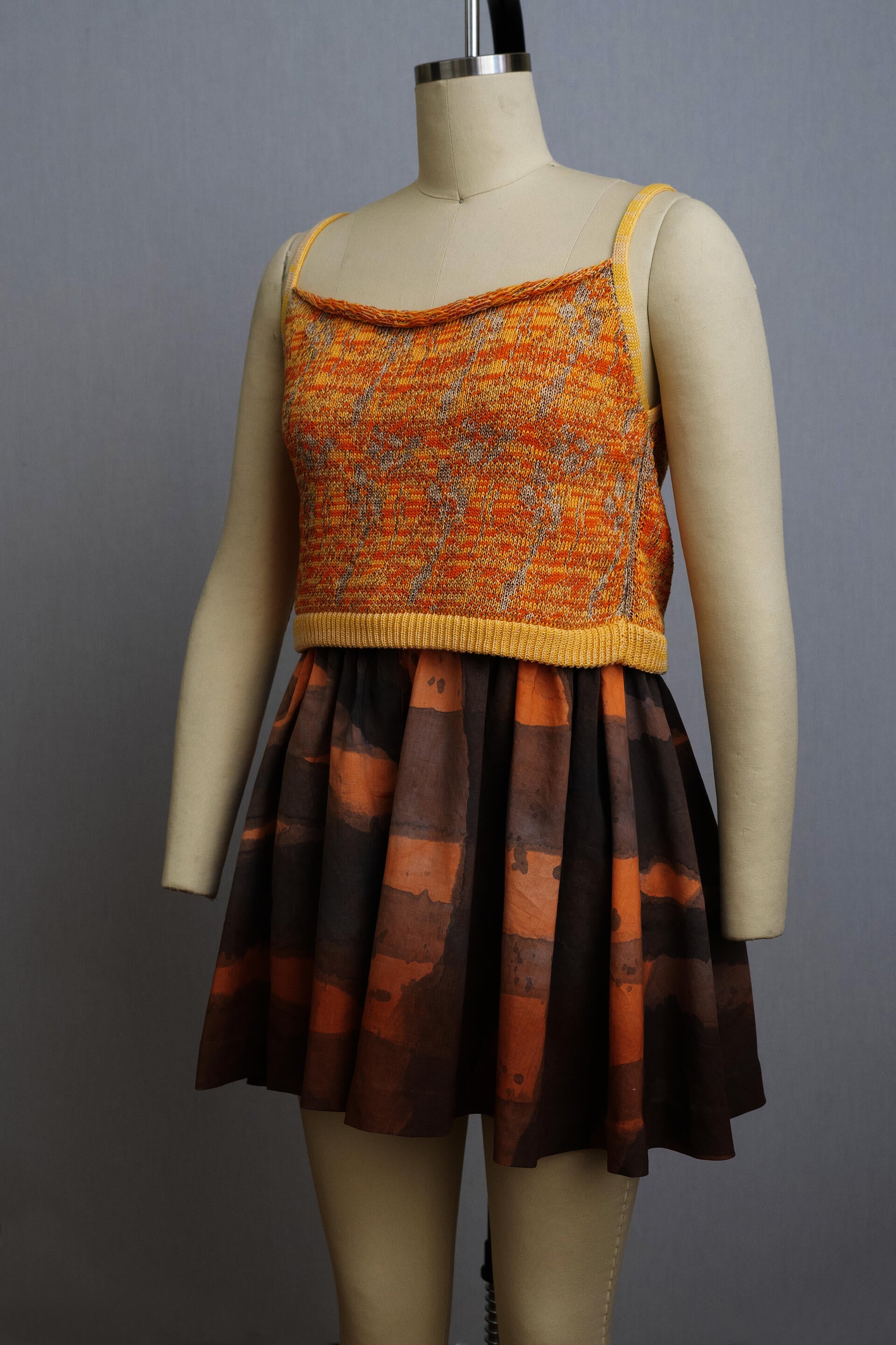 dress form wearing orange and yellow top with wide leg shorts in purple and orange