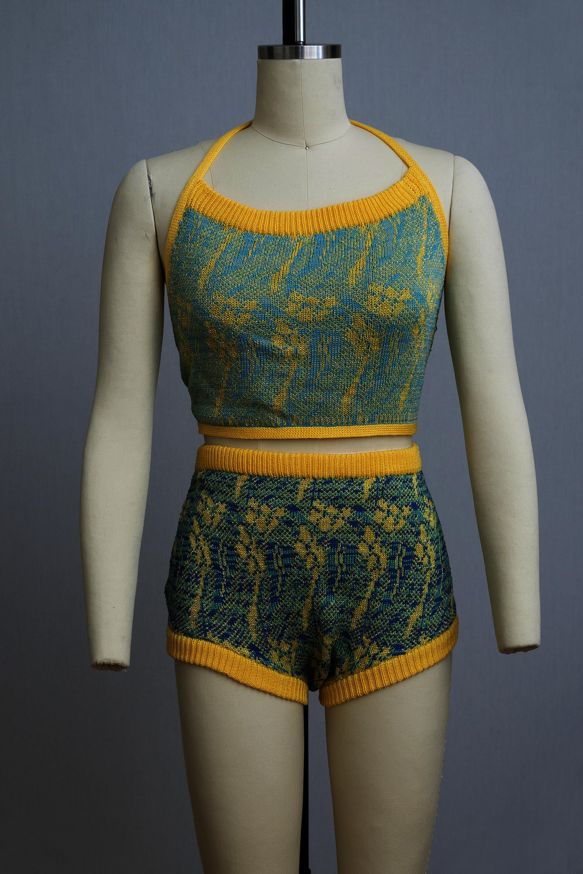 dress form wearing a knit playsuit in blues and yellows