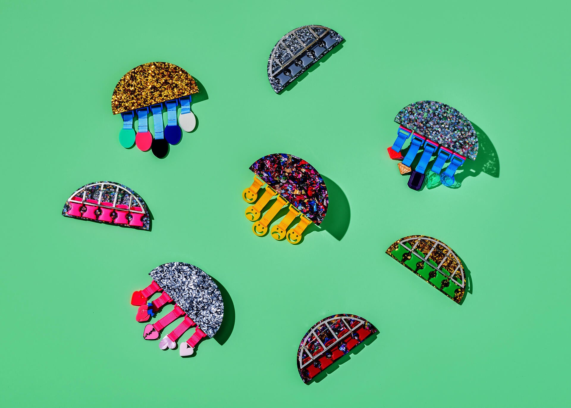 Art Over Time™ brooches with charms from the first four months of subscription