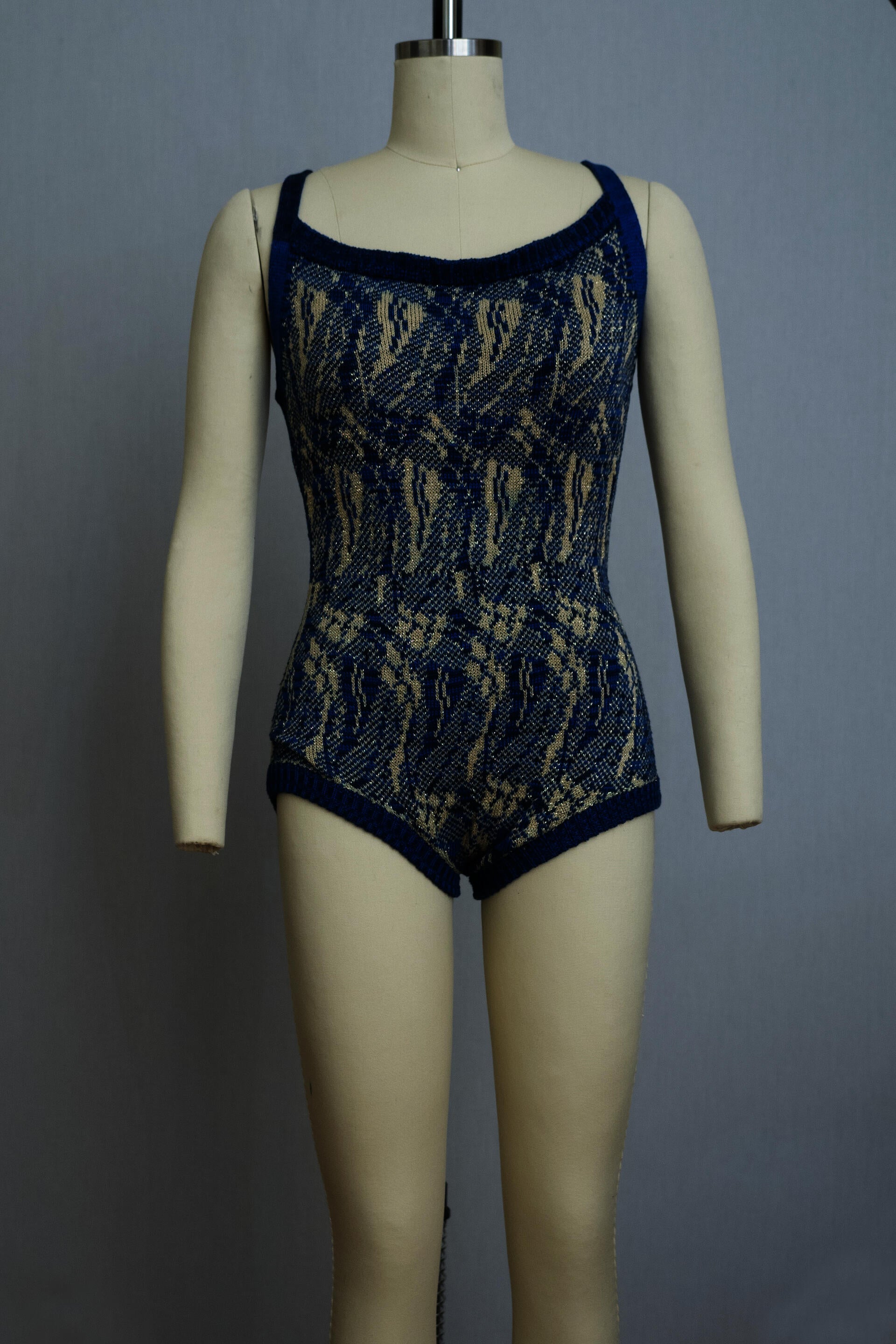 dress form wearing a knit playsuit in blues and yellows