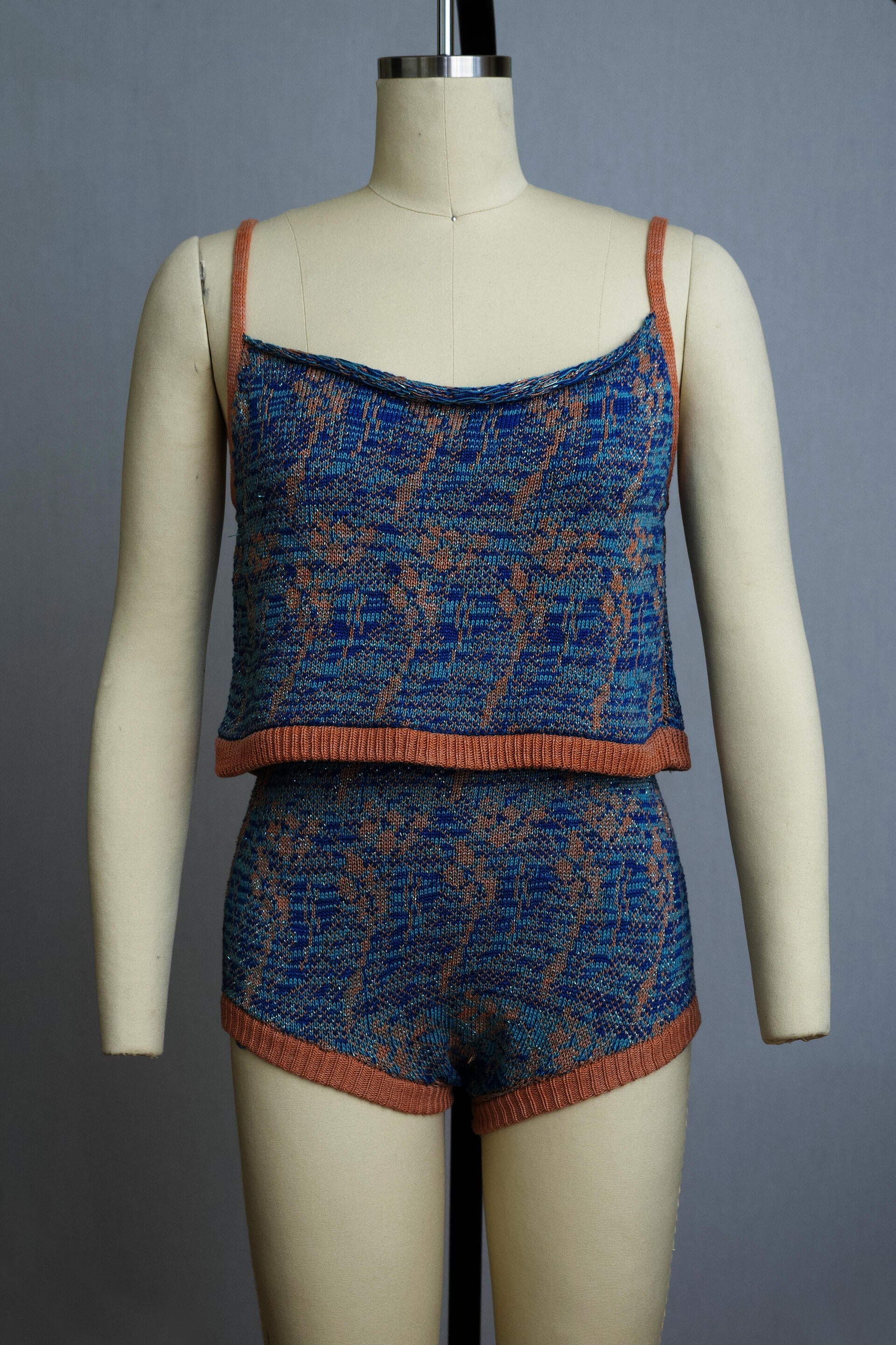 dress form wearing a knit playsuit in blues and pink