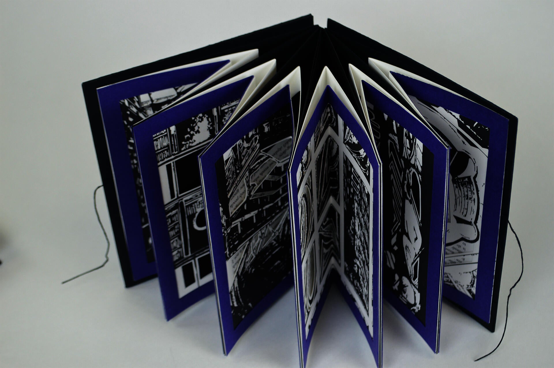 Carousel book depicting scenes of "The Library of Babel" written by Jorge Luis Borges