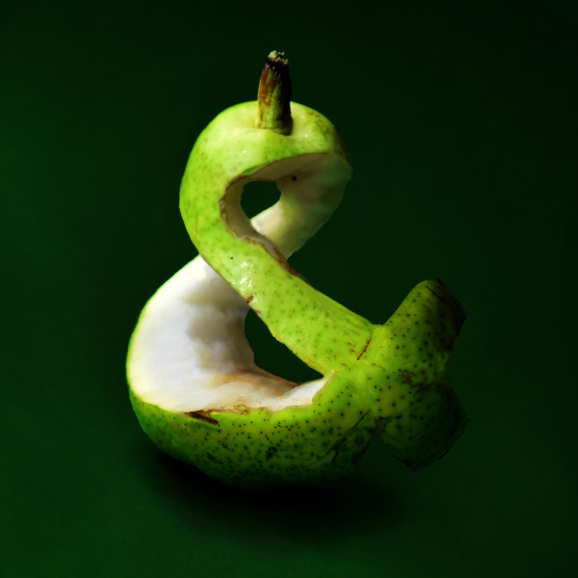 Green apple carved into an ampersand 