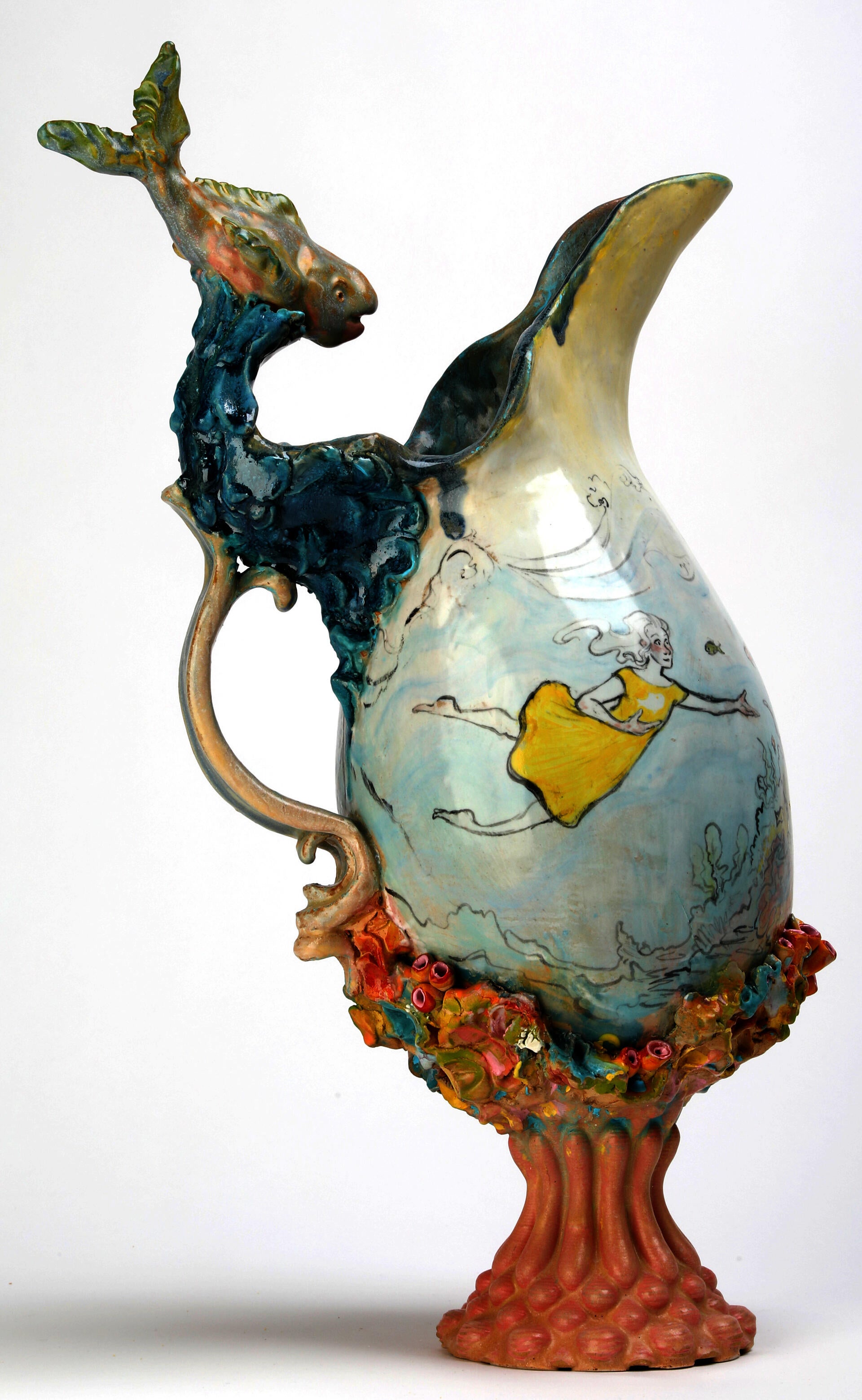 Pitcher with illustration of swimming girl, sculpted fish, and colorful detailing. 