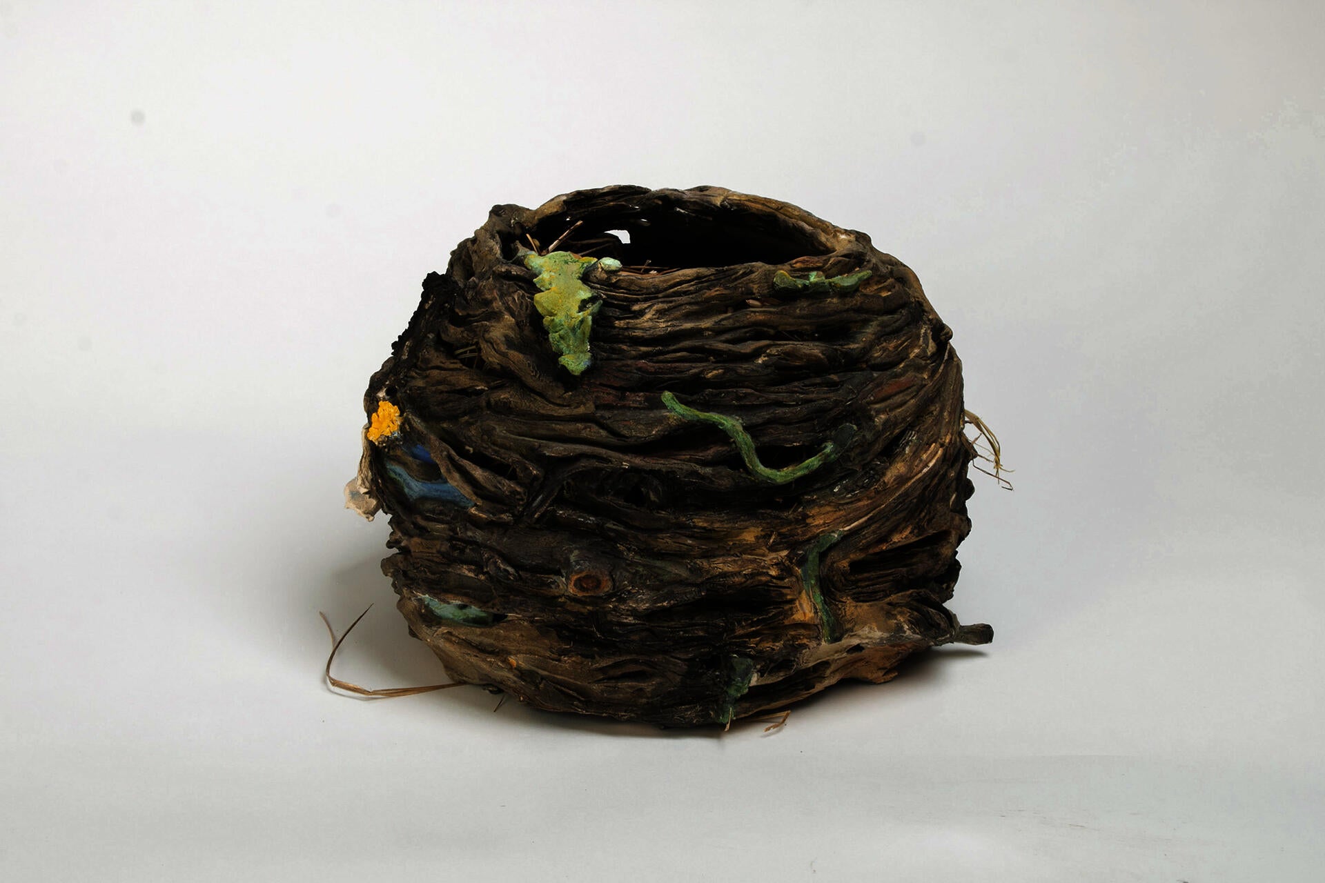 Ceramic nest sculpture with cattails and dandelions..
