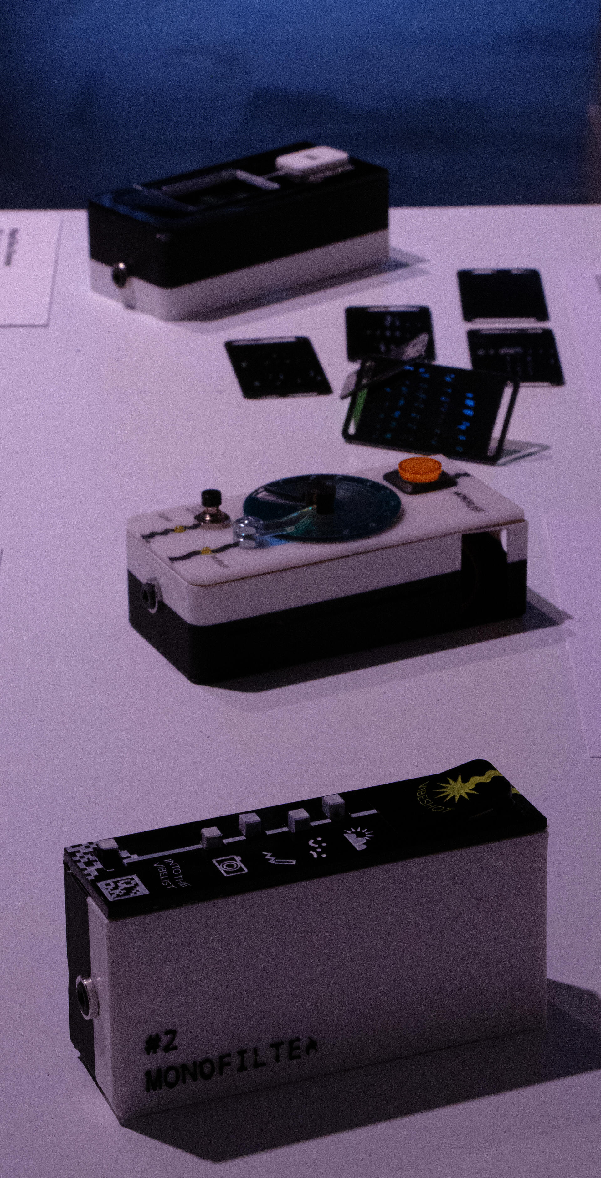 Portrait oriented photograph (vertical) showing the three devices. top to bottom: reaction tile, monofilter, vibelist. All in focus.