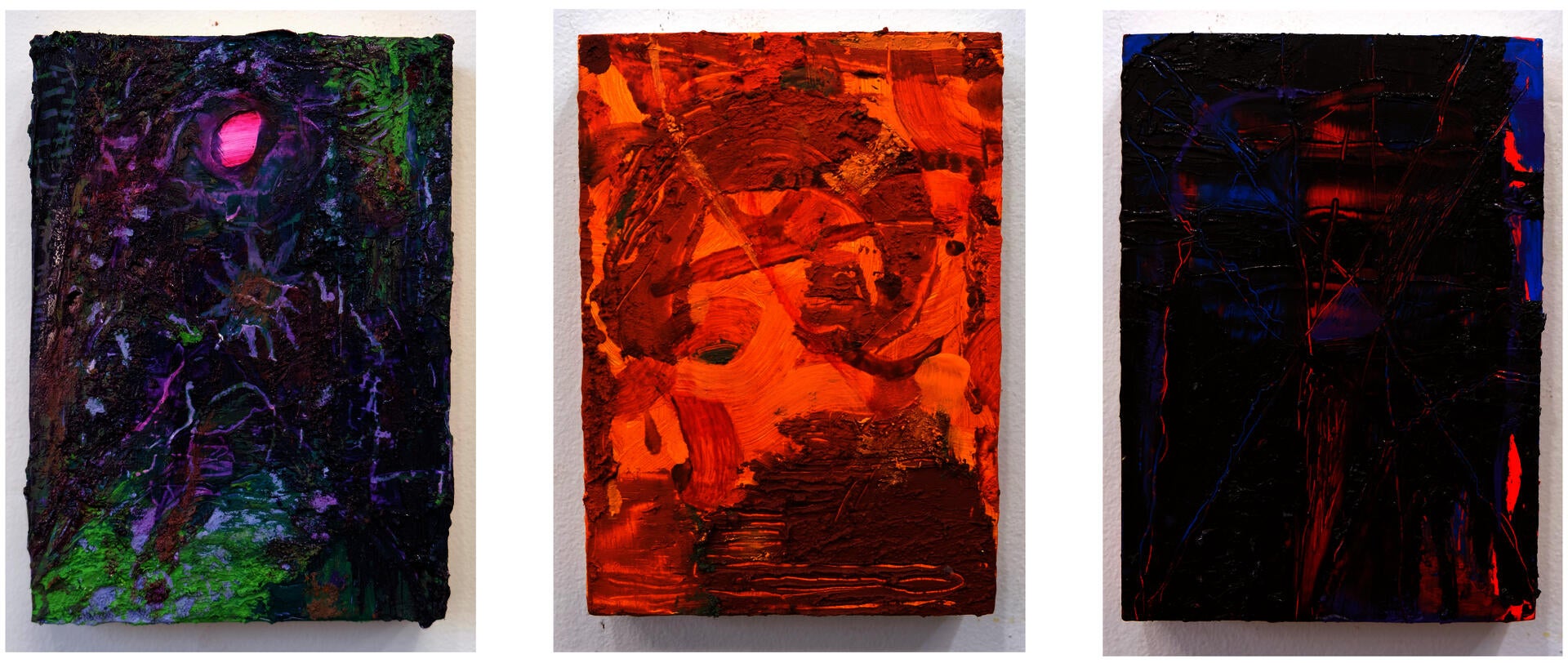 Photo of three small, abstract oil paintings.