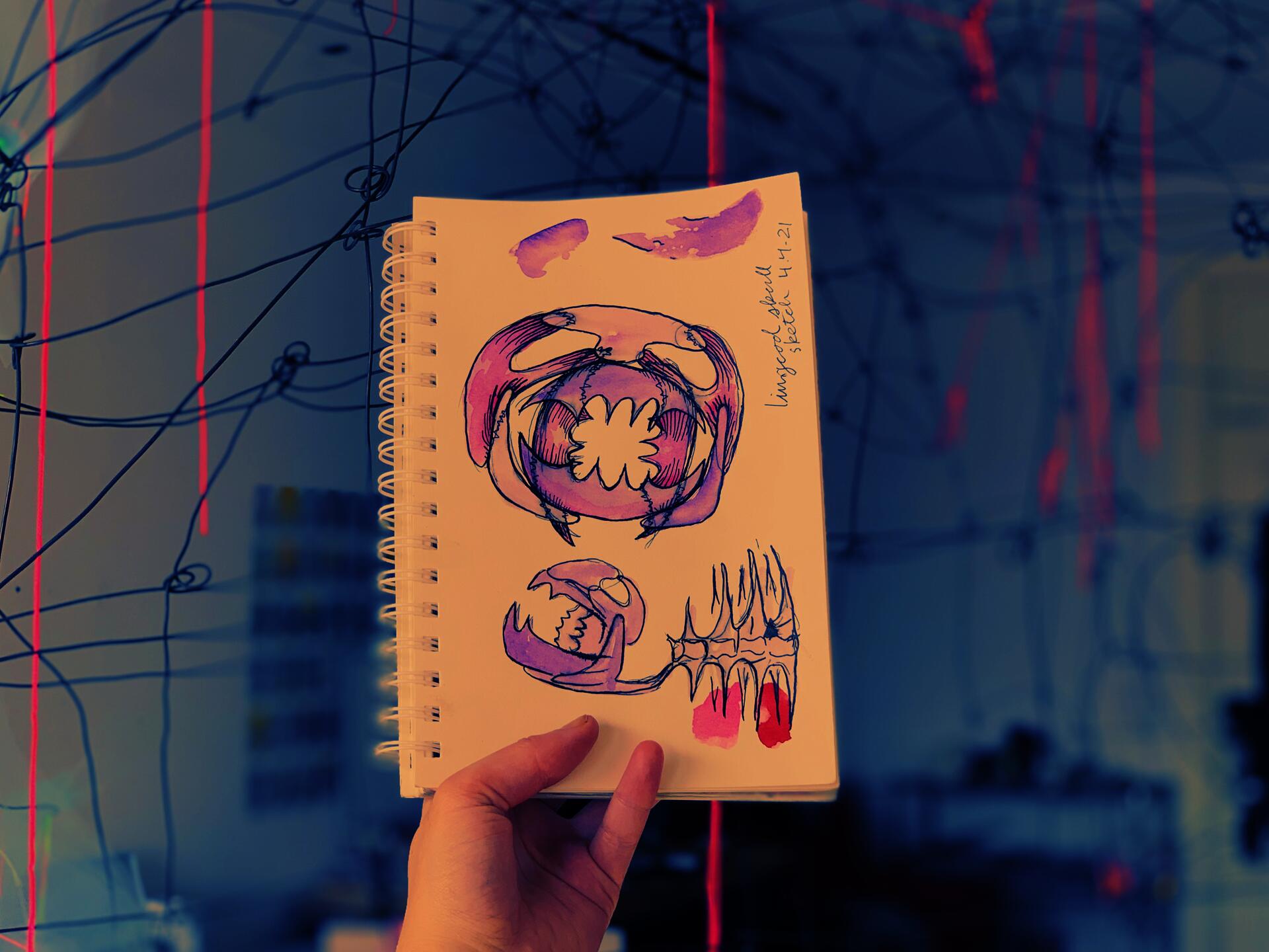Purple watercolor and ink sketch of how to turn a lingcod scull into a structure held by a hand in front of a blurred wire sculpture. - The Ephemeral Altar & The Floating Grave - Hannah Suzanna