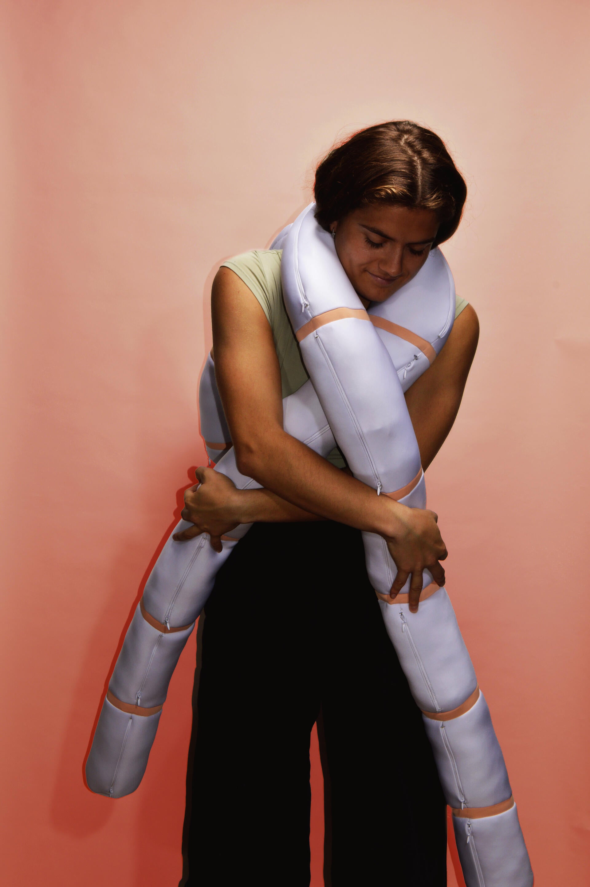 Color photograph, full body image with a girl holding Nudo in pink background
