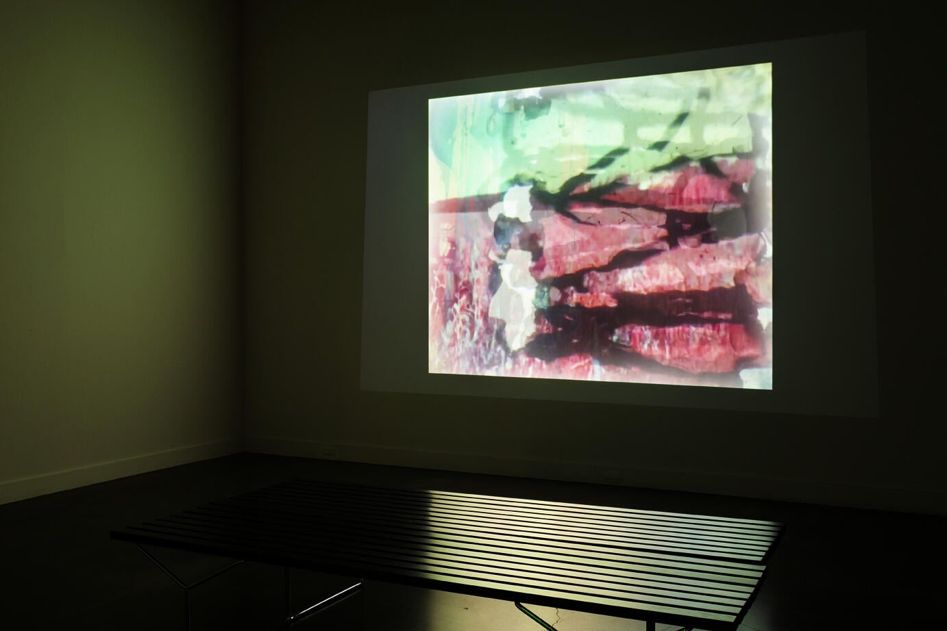 gallery interior; abstract colorful image projected onto a wall