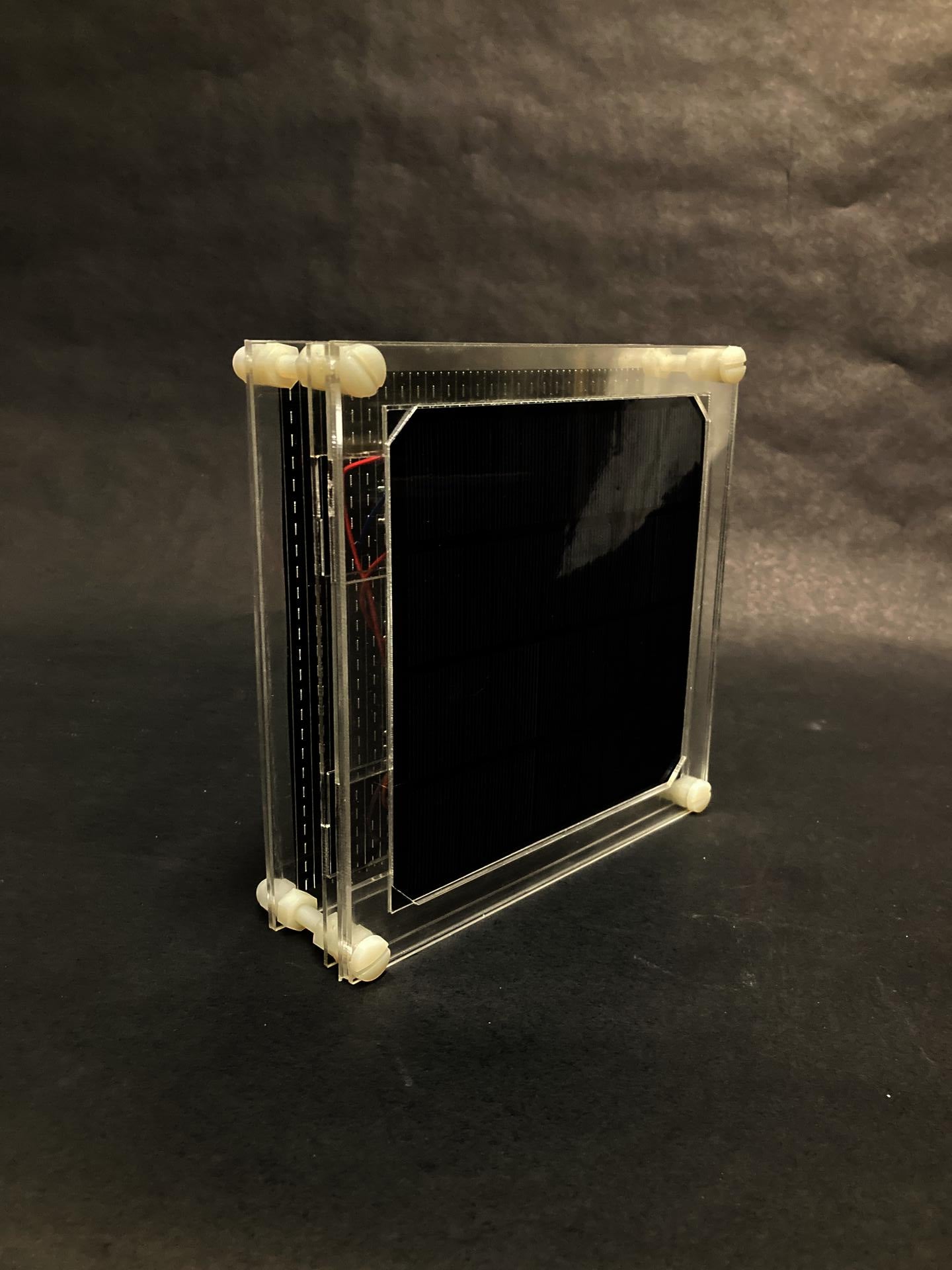 A framed solar cell, sitting on the table.