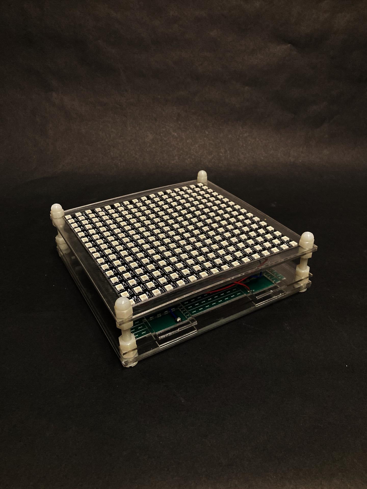 The acrylic frame holding a LED matrix facing up.