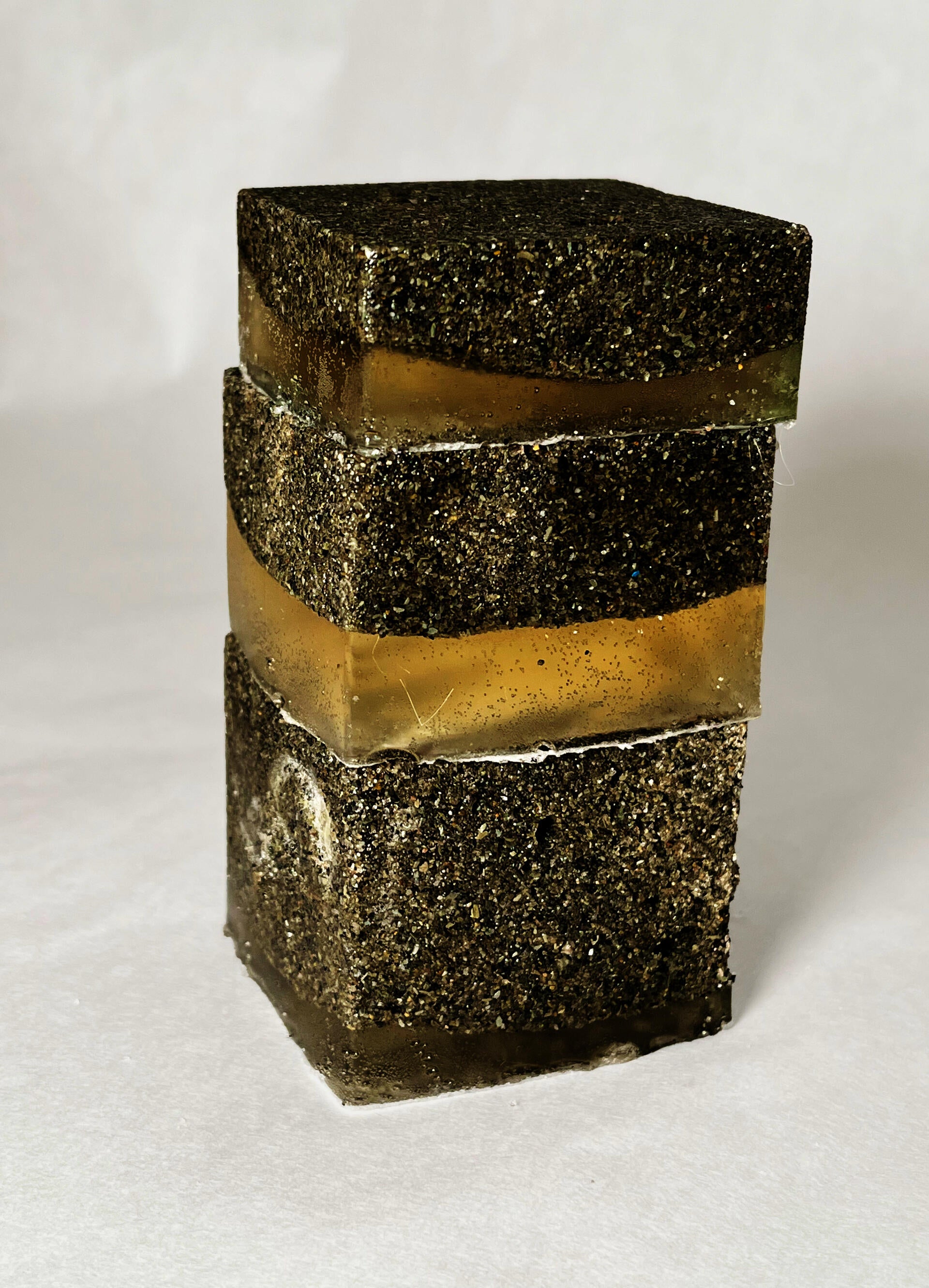 Stacked cubes left on the beach will allow for the gelatin to wash away and the aggregate to remain. 
