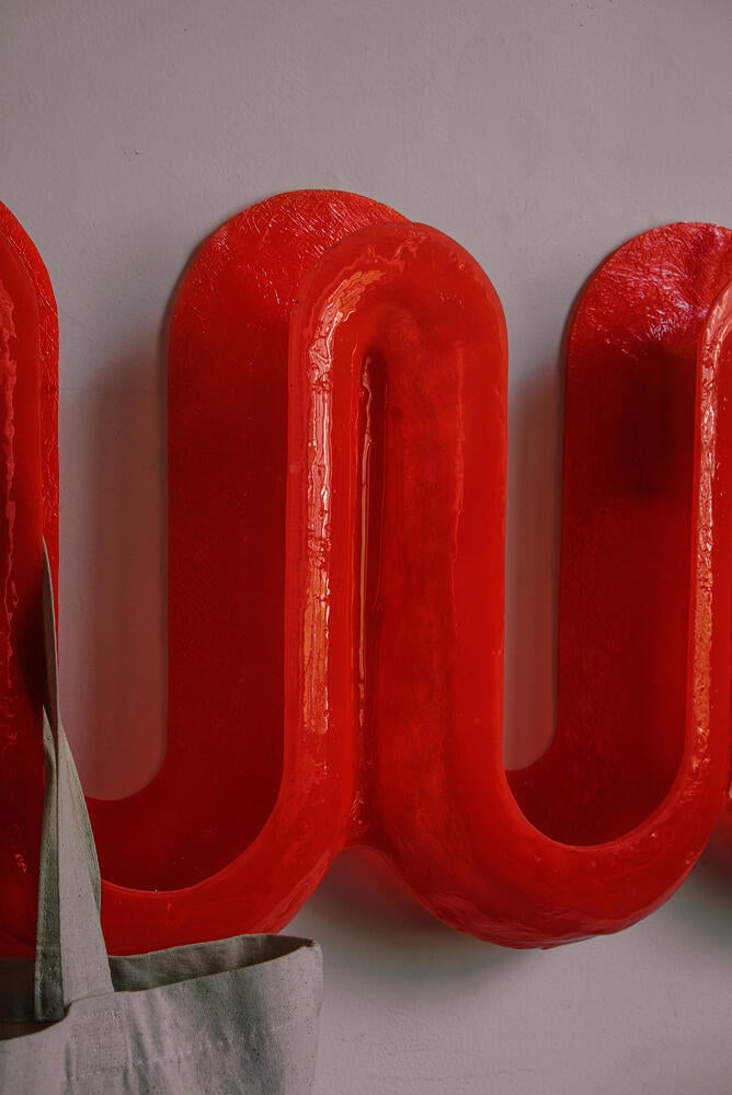 Detail image of red swell wall hooks.